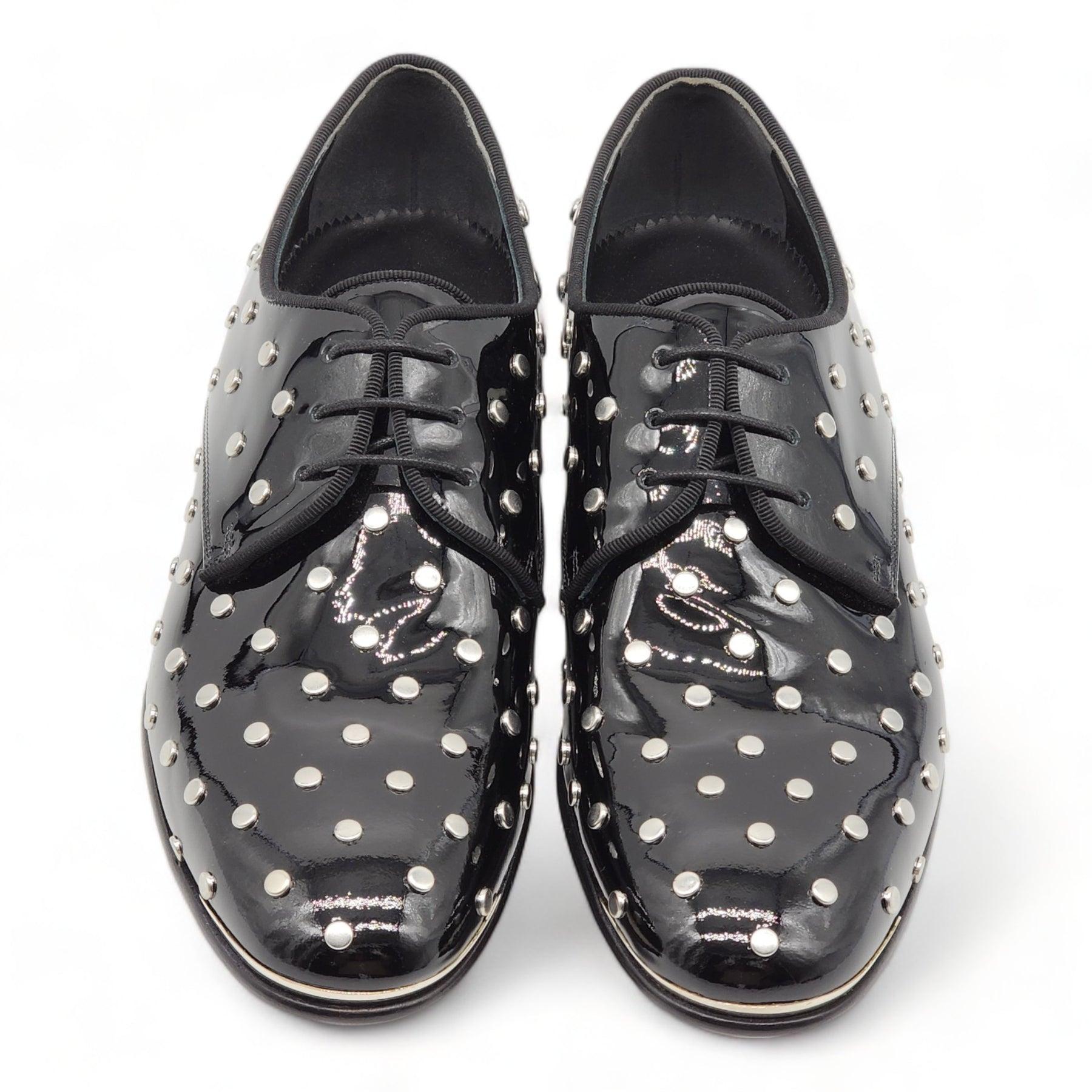Alexander McQueen Studded Derby Shoes with Patent Leather in Black
Patent leather lace ups by McQueen. Hand-studded all over.

Additional information:
Material: Leather
Color: Black
Size: 7 US
Country: Italy
Condition: New with box and