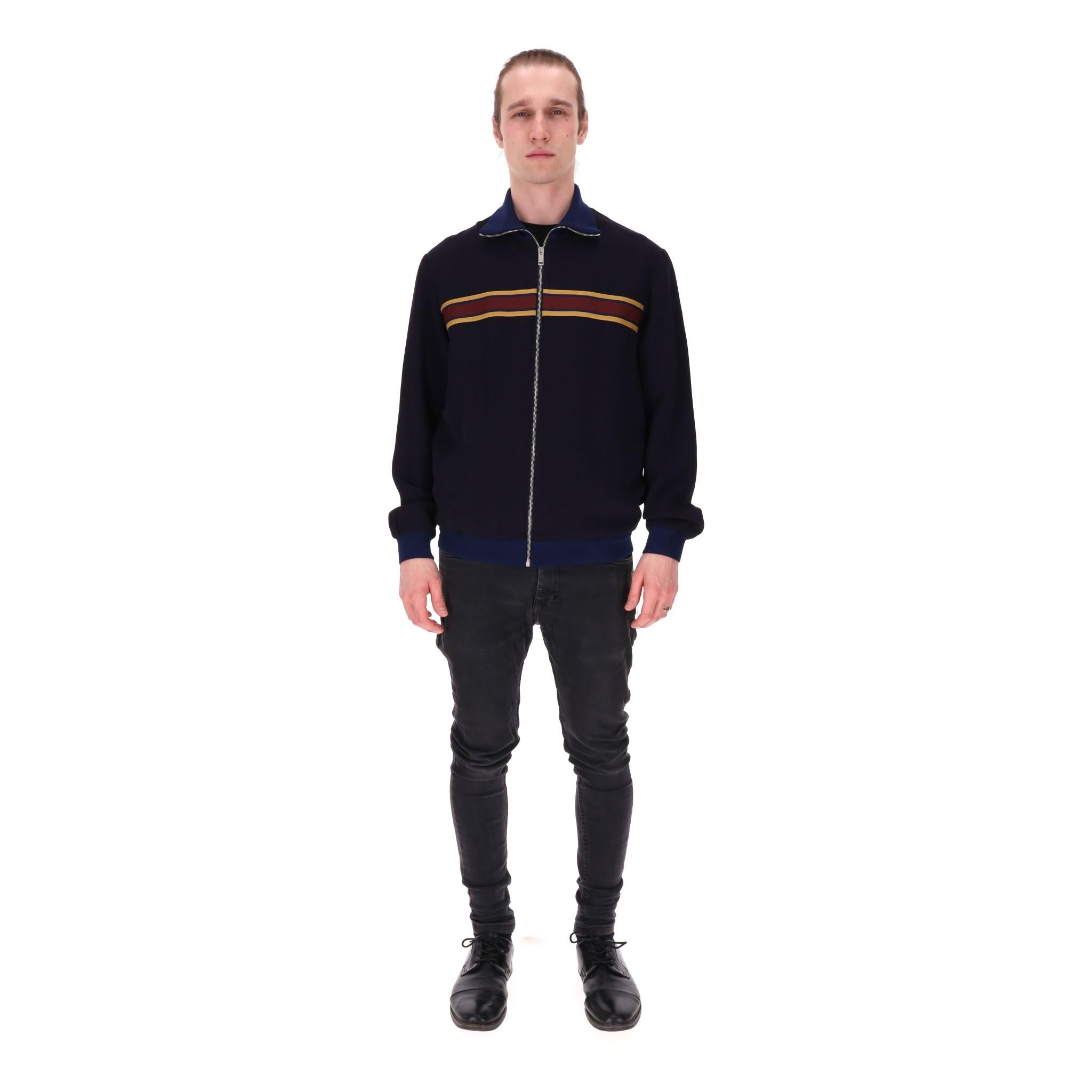 Alexander McQueen Track Jacket

Navy track jacket with stripe panel across the chest.

Featuring ribbed stand collar, cuffs and hem, centre zip closure.

Rrp Approx. £950

Size – 50IT

Condition – Good/Very Good (Some marks)

Composition – 74%