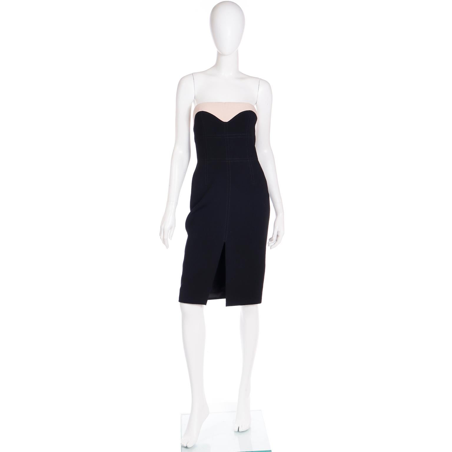 This Alexander McQueen black strapless dress would be a perfect little black dress to add to your wardrobe. The top of the dress has a 2'' Band of pink tinted beige the dramatic sweetheart neckline. The black fabric has a grid of top stitching