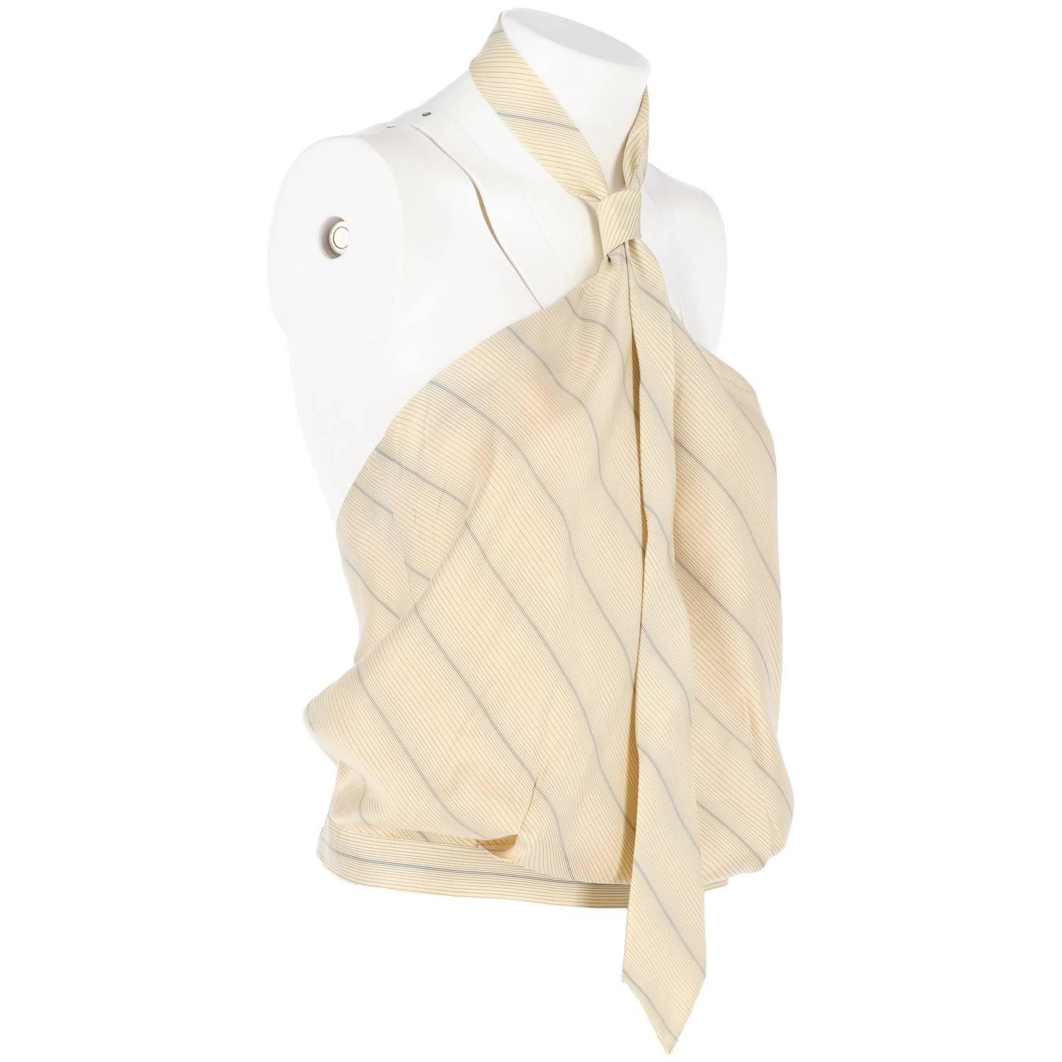 Vintage Alexander McQueen striped silk top with oblique patterned fabric tied to the neck like a necktie. Features a buttoned opening on the left hip, with one spare button on the inside label.
Excellent conditions.

Hips: 36 cm
