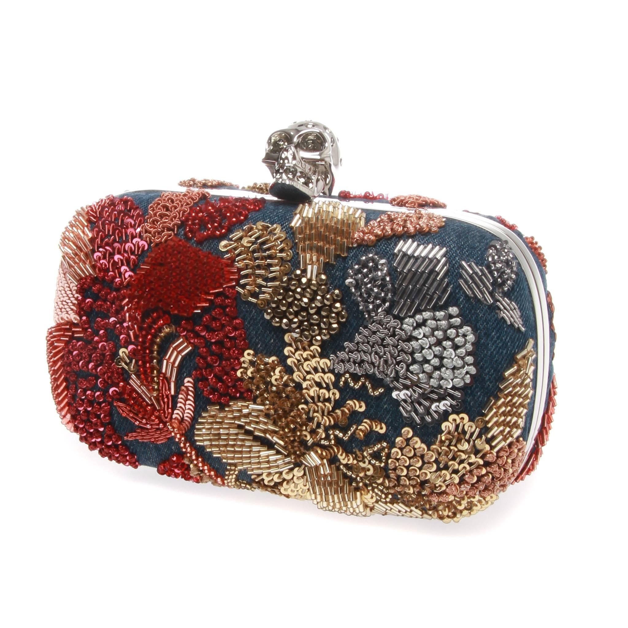 An exceptional-rare washed denim sequin embroidered clutch by ALEXANDER MCQUEEN.

It features Denim multi-colour flower embroidered skull clutch, front and back floral sequin embroidery and skull Clasp closure features Swarovski eyes.

Comes with