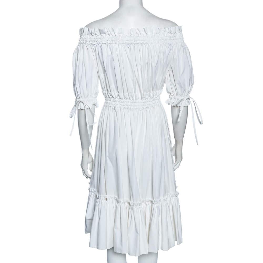 Creatively designed with white cotton, this charming dress from Alexander McQueen never fails to make you look elegant. This dress is highlighted with beautiful features that make it look rather pleasant. It displays an off-shoulder style with