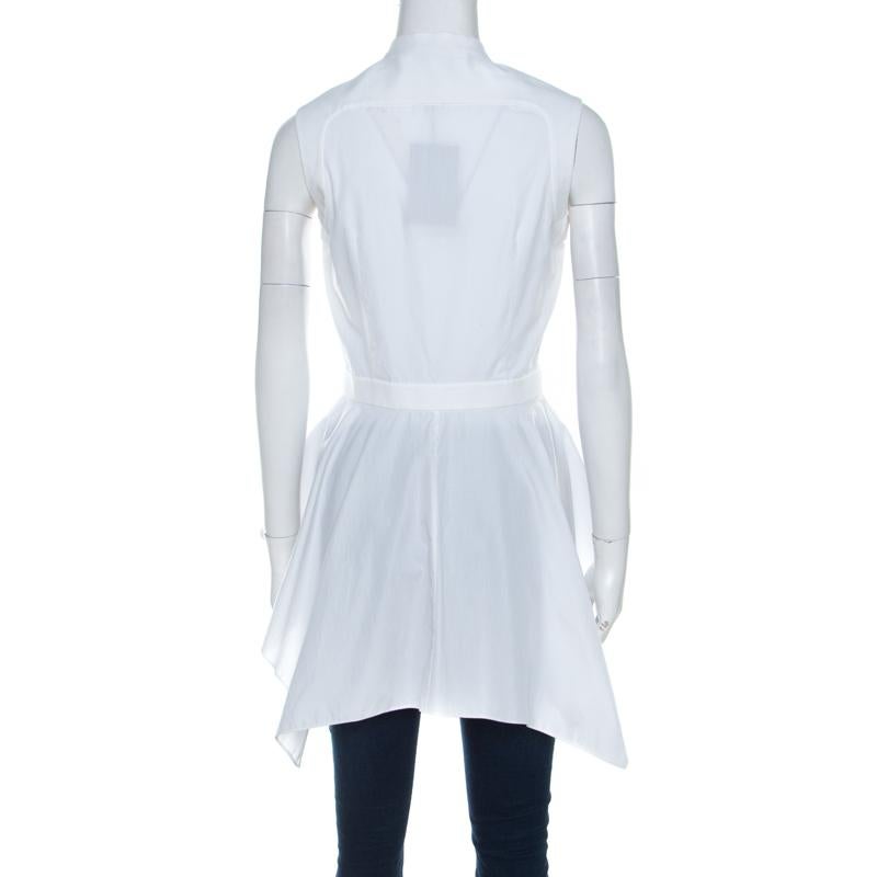 In a wardrobe of basics, this Alexander McQueen top is a breath of fresh air with its bold design. This elegant white top brings out the festive mood and revamps your look with its asymmetrical peplum hemline. This unique 100% cotton creation is