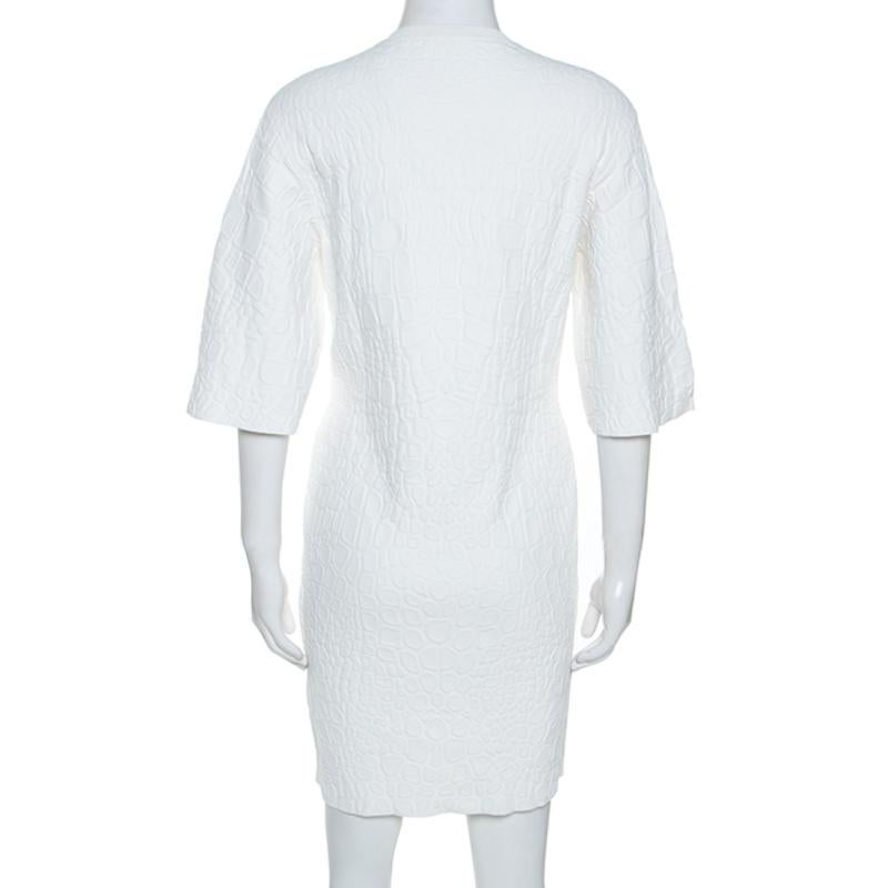 This chic dress from the house of Alexander McQueen will make you look like a diva. This understated white dress deserves a special place in your wardrobe. Brilliantly made with crocodile-embossed fabric, this dress offers a unique touch to your