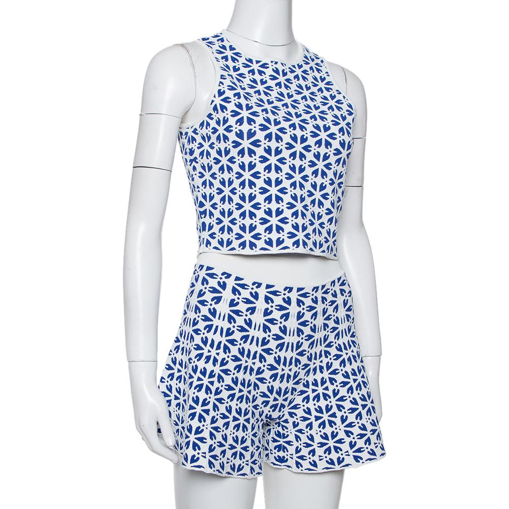 This trendy and classy top and short set from the house of Alexander McQueen will just take your breath away! The navy blue and white creation is made of a viscose blend and features an embossed floral jacquard pattern. The cropped top flaunts a