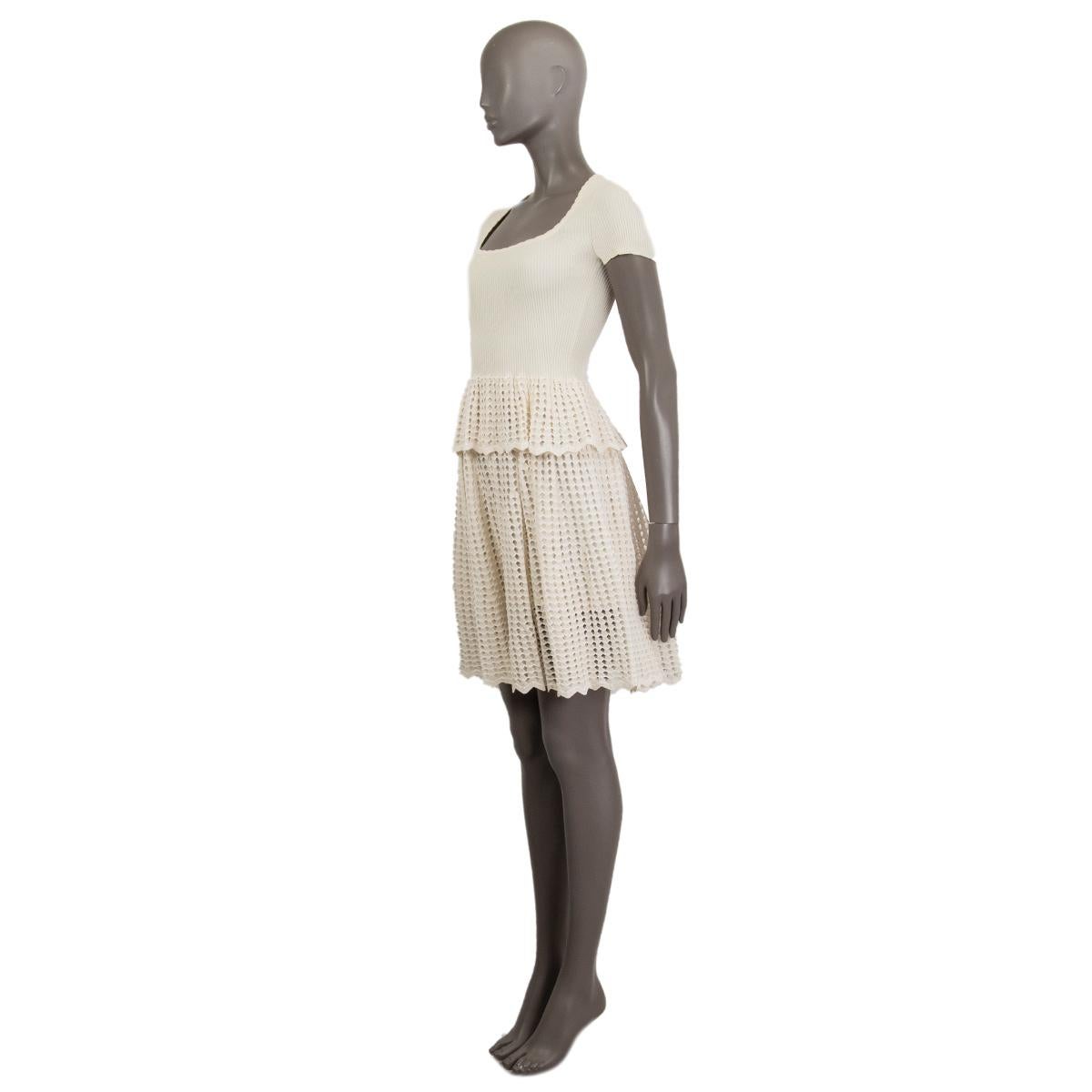 Alexander McQueen ribbed and open knit peplum dress in cream polyamide (43%), cotton (37%), viscose (11%), nylon (5%) and polyester (4%). Has short sleeves and a solid knit skirt. Has been worn and is in excellent condition.

Tag Size S
Size