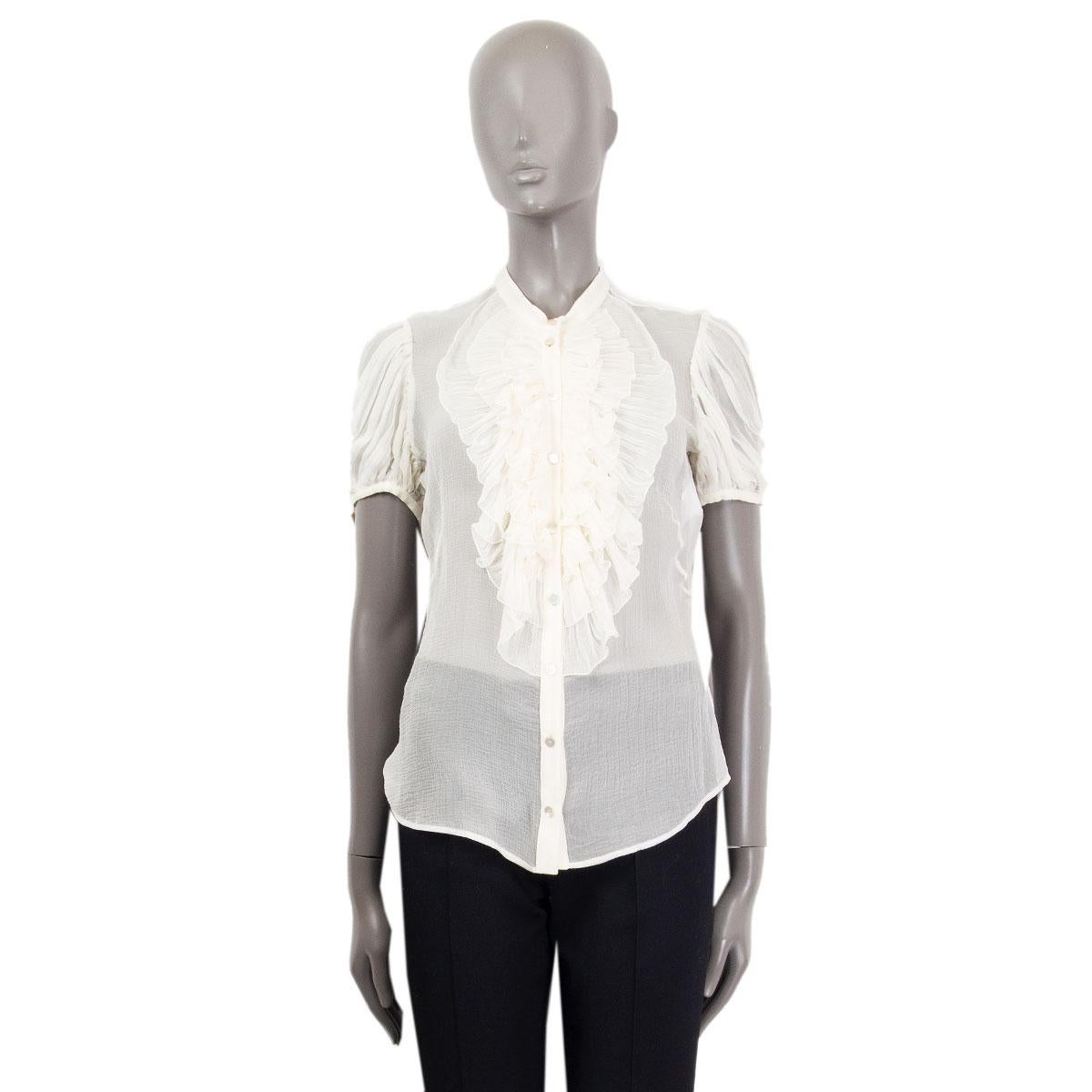 Alexander McQueen ruffled sheer button-up blouse in off-white silk (100%) with gahtered puff short-sleeves. Front is slightly longer than the back. Has been worn and is in excellent condition. 

Tag Size 44
Size L
Shoulder Width 39cm (15.2in)
Bust