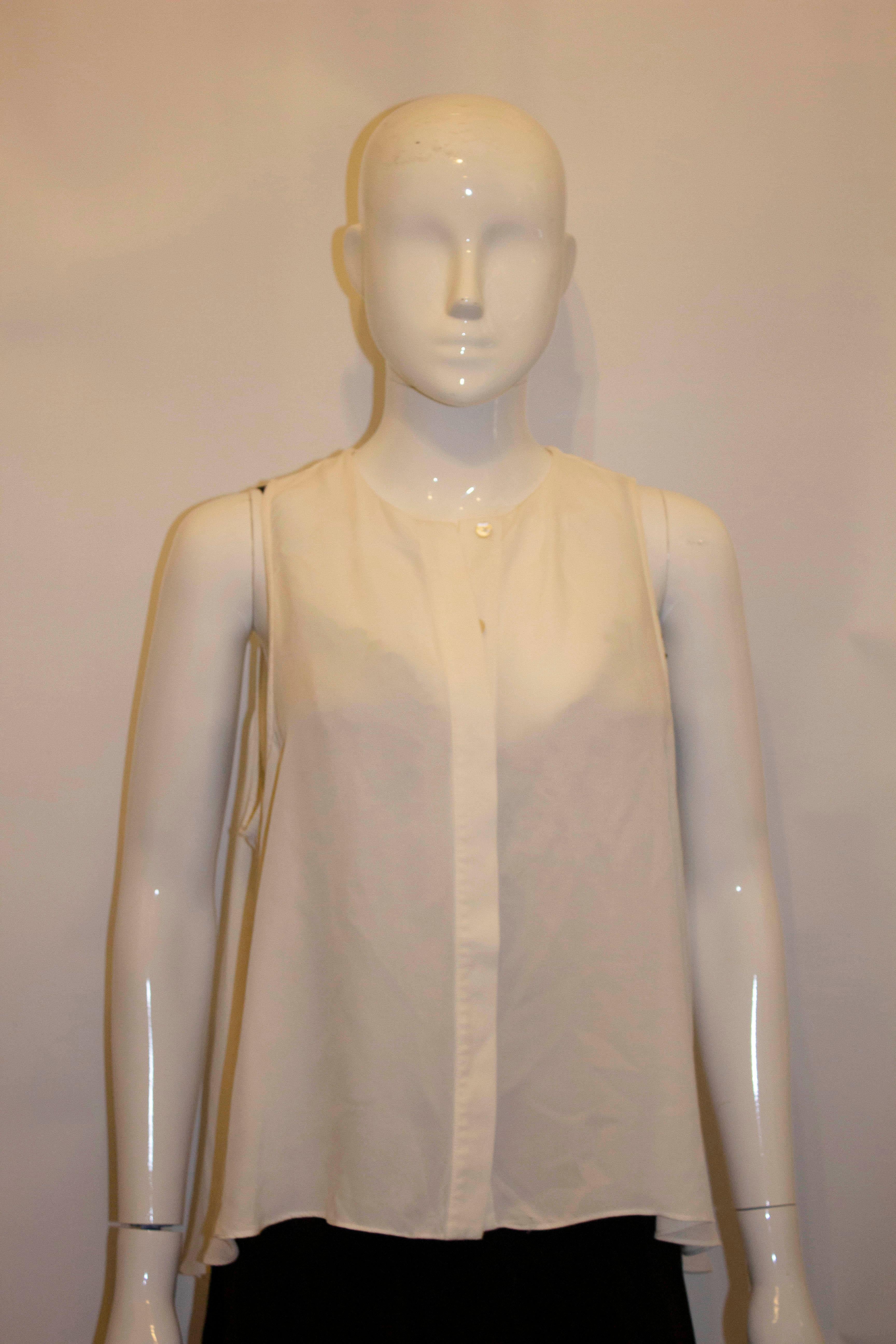 A chic and easy to wear white silk top by Alexander McQueen. The A line top , has a a front button ( hidden ) opening and is longer at the back than the front. 
Size IT 44 But up to 42'', but look better loose, length front 21', back 23''