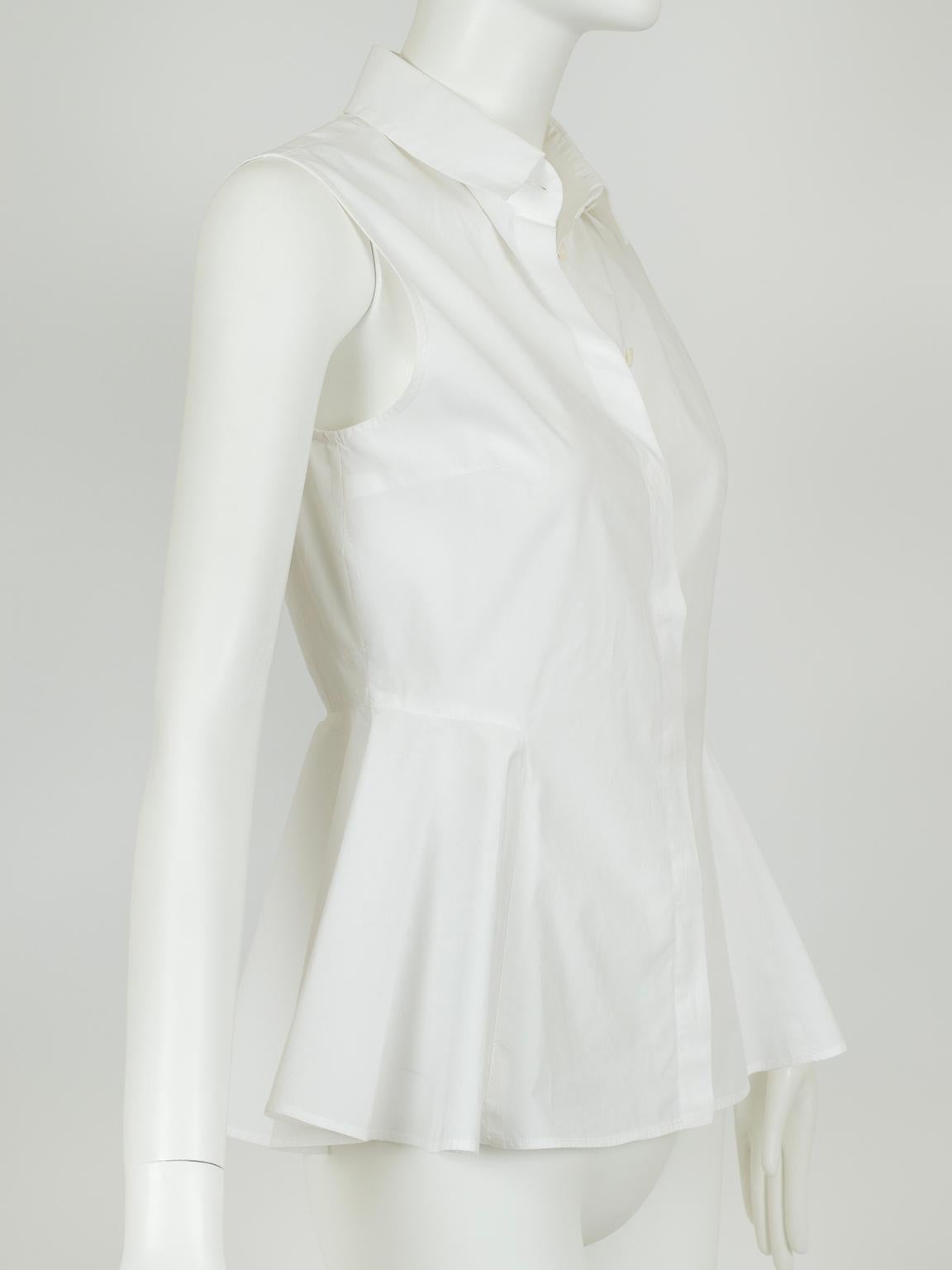 Famous for elevating the pedestrian into a work of art, McQueen’s Sarah Burton reimagines the plain white shirt with her use of an exaggerated peplum. Its sculptural silhouette and nipped waist impart 1950s-era femininity to a garment most typically