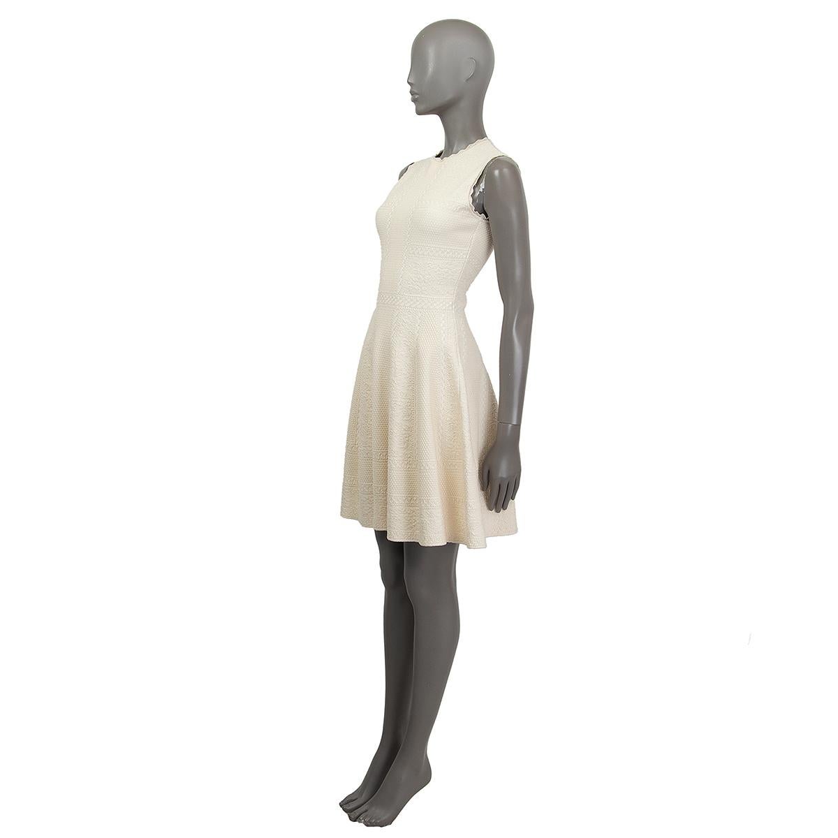Alexander McQueen sleeveless jacquard knit dress in cream and white viscose (54%), silk (35%) and polyester (11%). Has scallopped knit neckline and arm openings, flared skirt. Has been worn and is in excellent condition.

Tag Size S
Size S
Bust 78cm