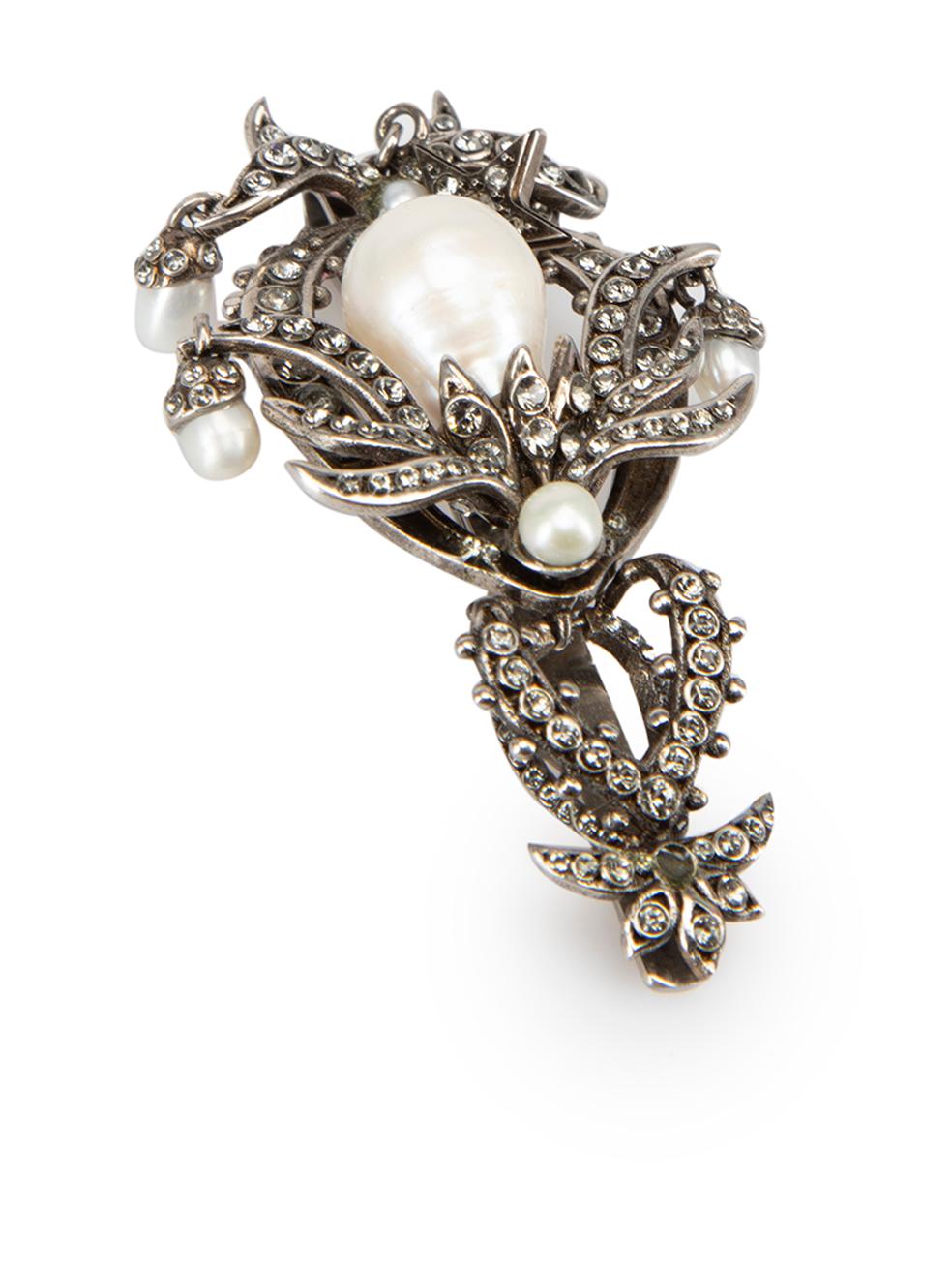 CONDITION is Good. Minor wear to clip is evident. Light wear to the rear clip with light scratches and light wear to the main pearl, with glue mark at the bottom with the attached crystal on this used Alexander McQueen designer resale