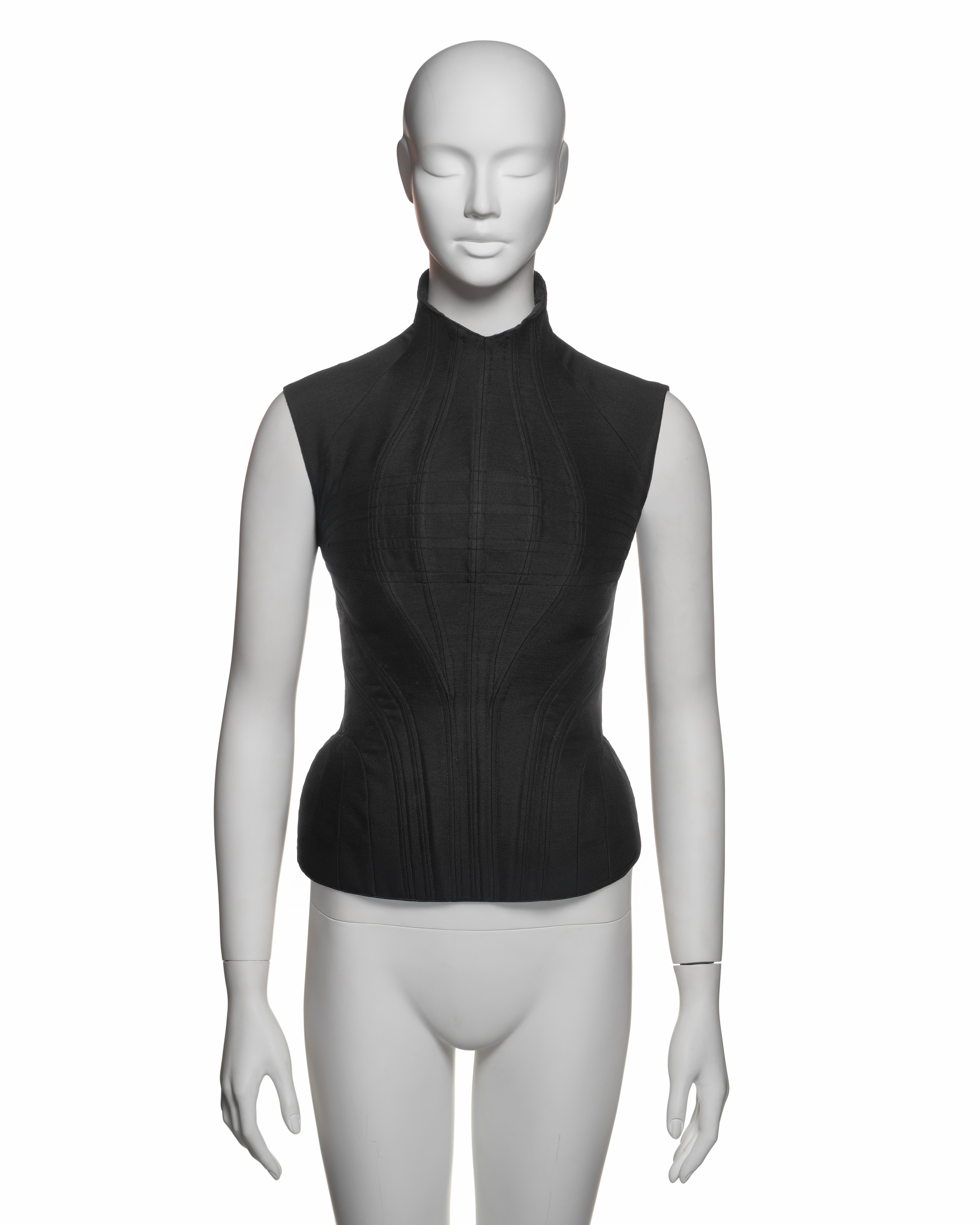 This Alexander McQueen corset from Fall-Winter 2000 is made from a wool and silk blend. It features hook-and-eye closures along the back. The corset is boned throughout to shape the chest and waist. Seaming around the hips adds volume, creating a