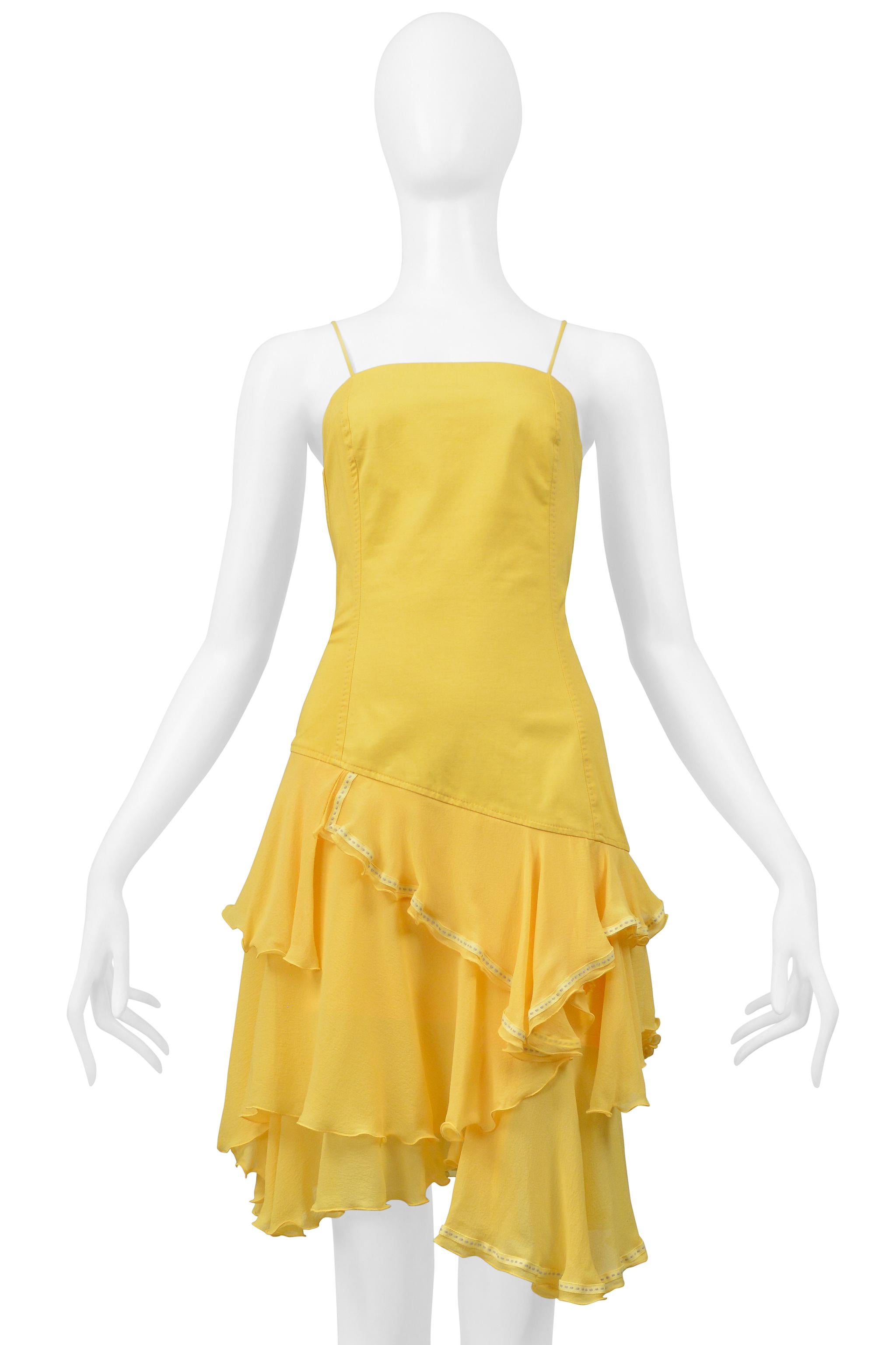Resurrection Vintage is thrilled to offer a vintage Alexander McQueen yellow dress from the Hunger Collection. The dress features an asymmetrical drop waist, a layered chiffon skirt with contrasting topstitched ribbon details above the knee length,
