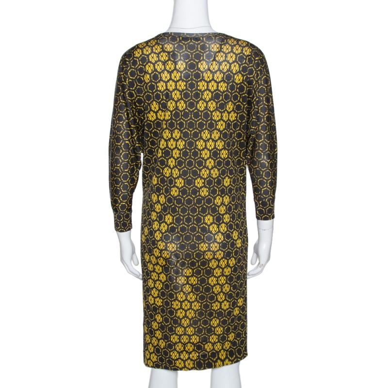 Designed to contrast light against dark, Alexander McQueen uses shades of yellow to characterise this dress. Three-quarter sleeves and a round neck contribute to its demure silhouette. An intricate honeycomb pattern adds to the design of this shift