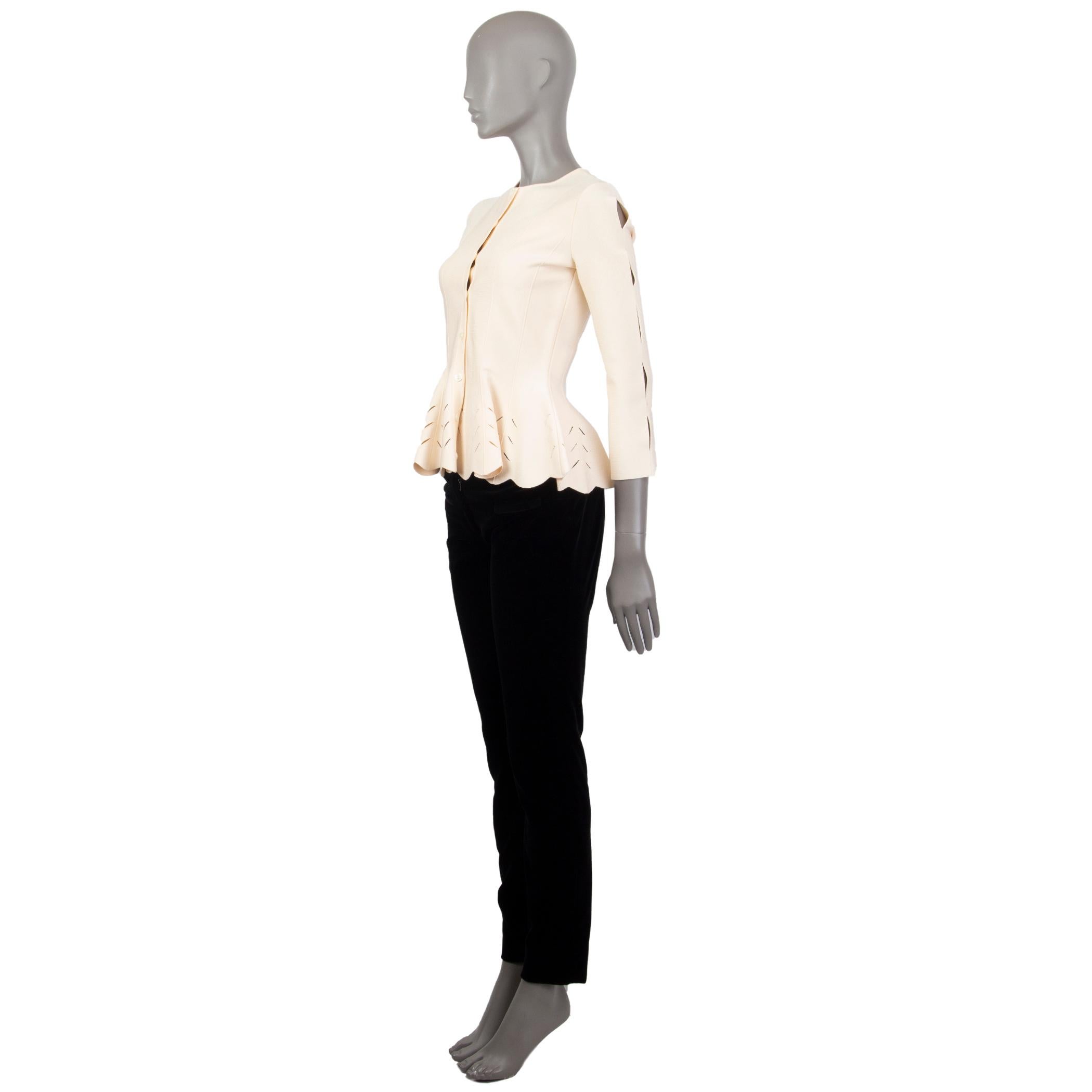Alexander McQueen perforated-peplum cardigan in champagne viscose (83%) polyester (17%) with an hour-glass fit, detailed seam-lines, crew neck, 3/4 arms with cut-outs along the arms down. Closes with button fastening in the front. Has been worn and