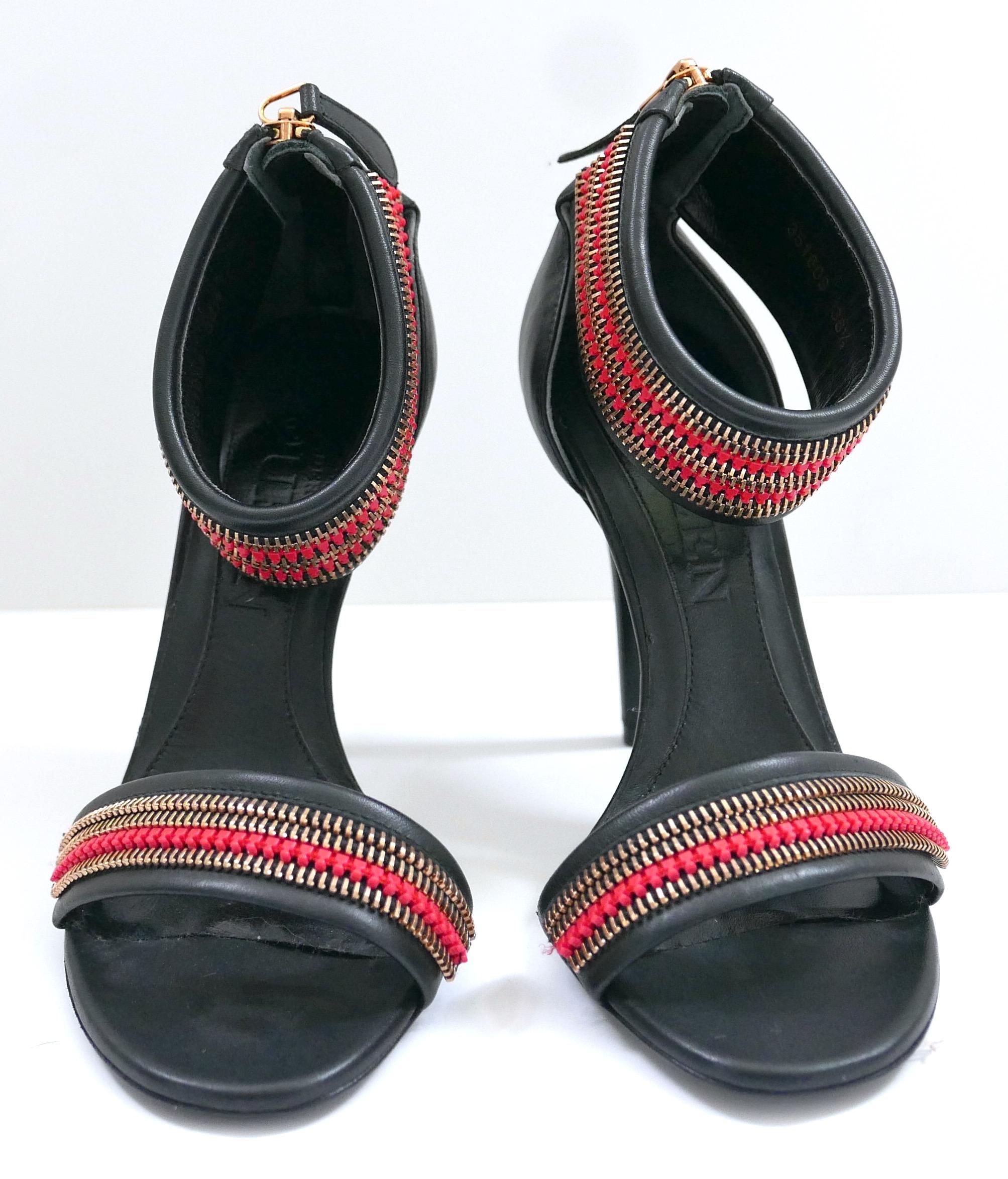 Stunning archival Alexander McQueen zipper trim sandals. Unworn with dustbag. Made from smooth black leather with goldtone and red zipper trims, zip backs and stiletto heels. Size 36.5/UK3.5. Measure approx - heel to toe 9.75” heel 4”. Little insole
