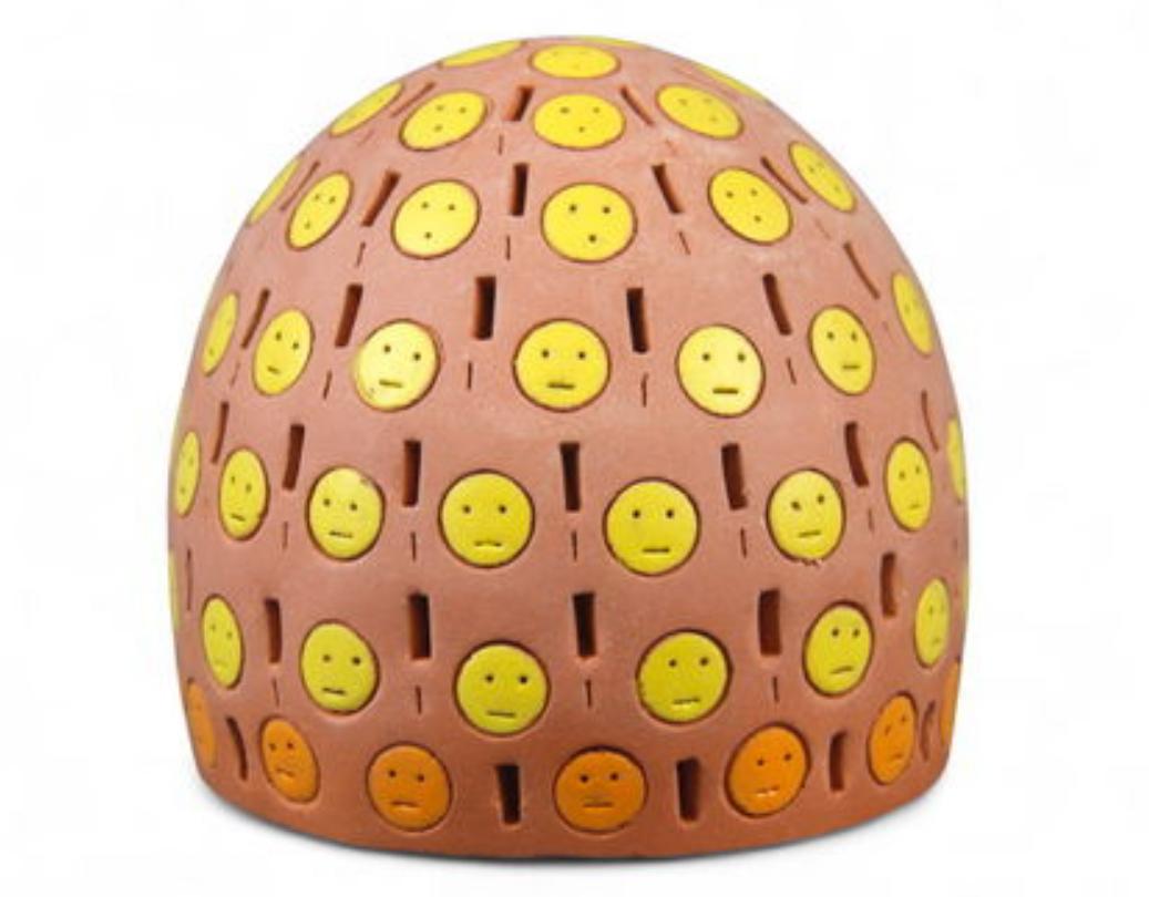 Unique original signed terracotta sculpture by Alexander Ney (Russian-American, 1939-2023), featuring a vividly painted and perforated head form in rich earthen tones with accents of yellow, blue, and orange. The design incorporates Ney's