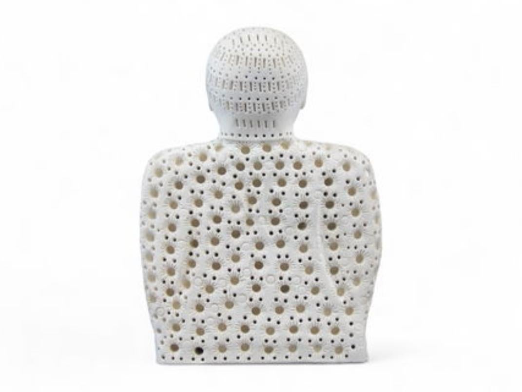 Original signed terracotta sculpture by Alexander Ney (Russian-American, 1939-2023) depicting a stylized seated figure with the artist's signature perforated and patterned surface texture. The figure features a distinctive mask-like face and an