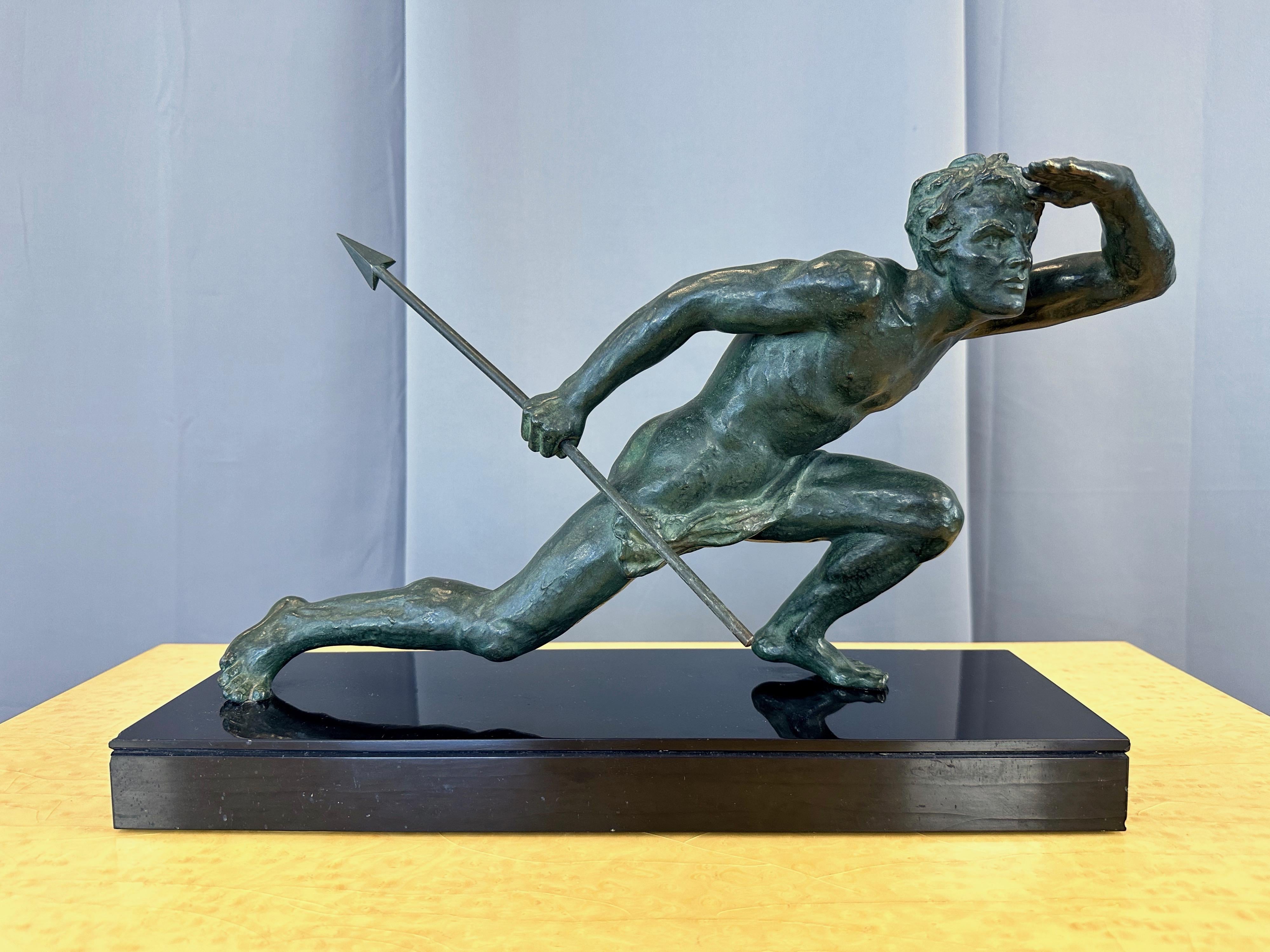 An exquisite signed Art Deco cast verdigris bronze sculpture of a male figure with spear on black marble base titled “Le Guetteur au Javelot” by Belgian sculptor Alexandre Ouline. 

Originally sculpted circa 1930—the well known Ouline was active in