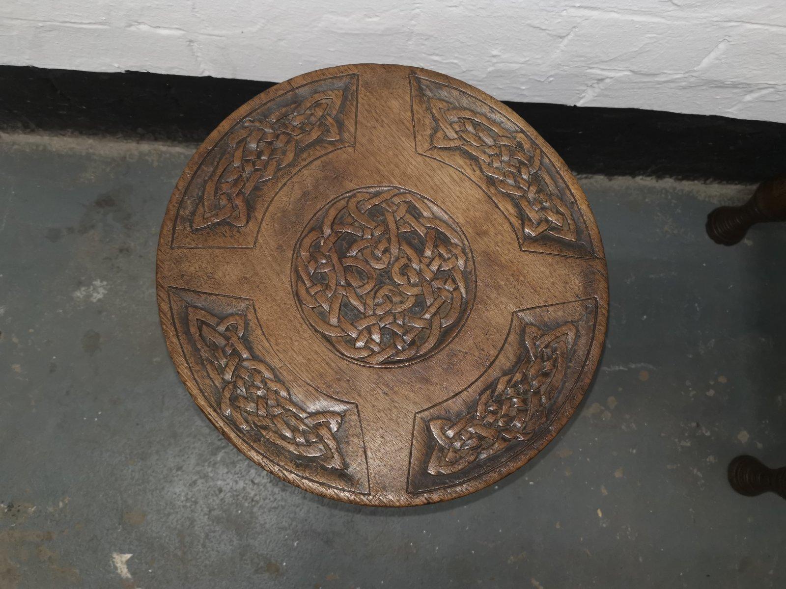 Alexander Ritchie of Iona.
A rare Arts & Crafts Glasgow School stool with carved Celtic interlacing decoration to the seat, and to the base. The four upright are further carved with Celtic crosses to the tops and bottoms of all of those uprights.