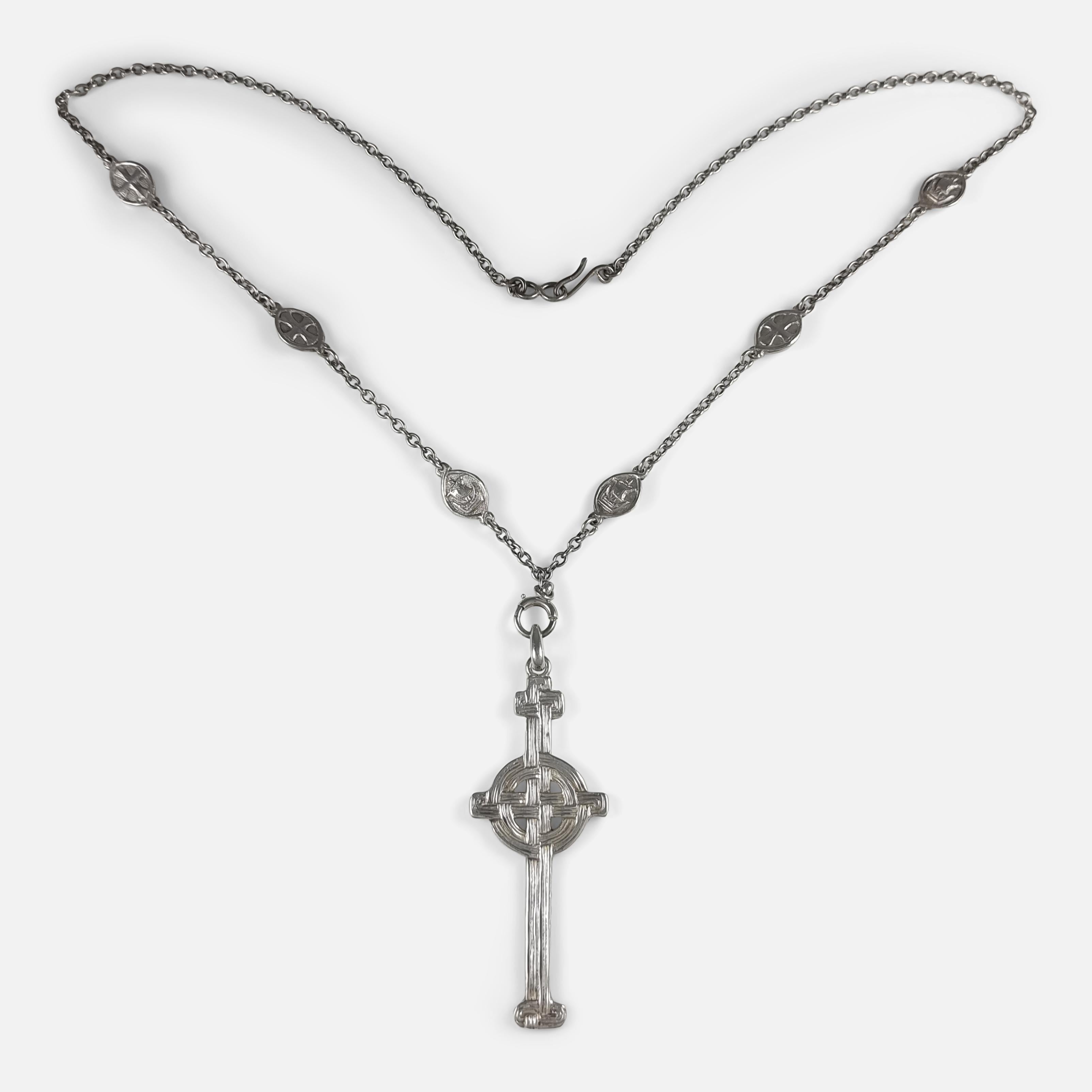 A Scottish Celtic revival Iona silver cross pendant by Alexander Ritchie, suspended on an unmarked trace link chain featuring Celtic motifs.

It is hallmarked with Glasgow assay marks, date letter 