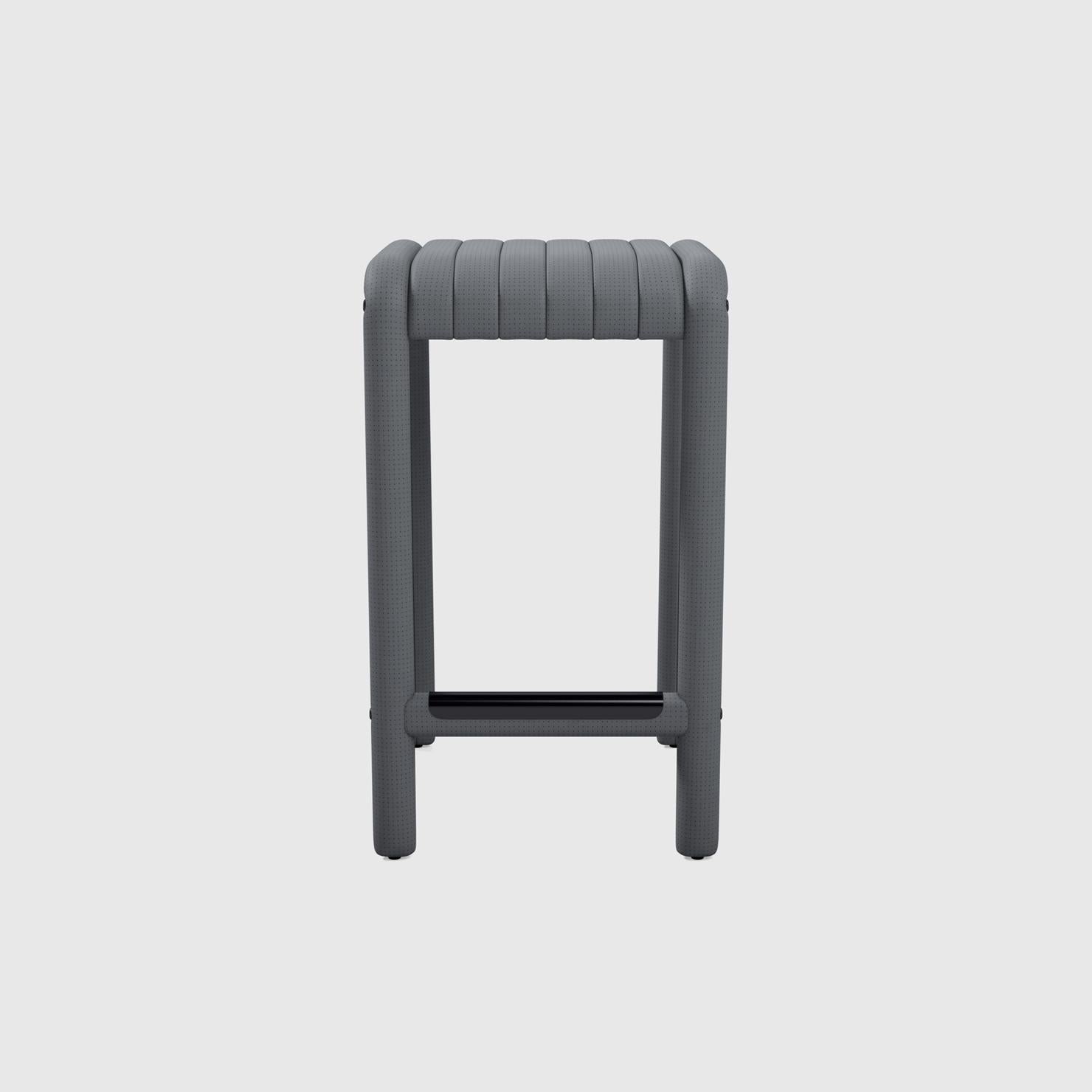 The Alexander Street counter stool by Philippe Malouin evokes the leather sports seats of iconic sports cars of the 1980s he grew up with on Alexander Street in Montreal. Ribbed and perforated leather is hand-stitched over the entire piece. The