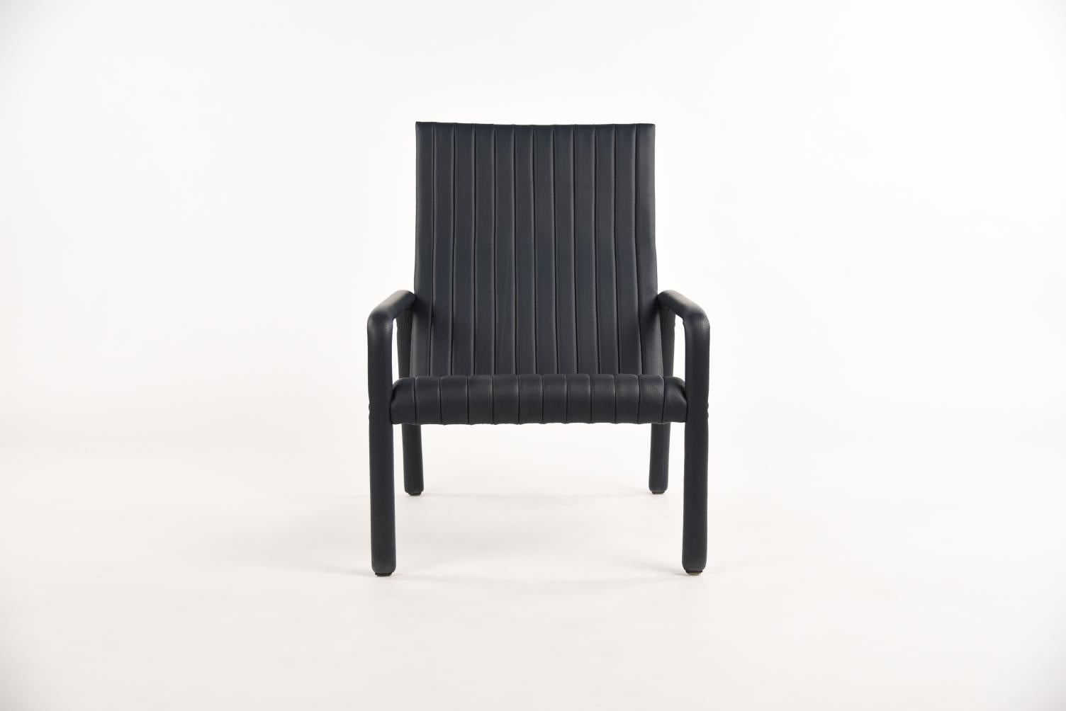 The Alexander street lounge chair by Philippe Malouin evokes the leather sports seats of iconic sports cars of the 1980s he grew up with on Alexander Street in Montreal. Ribbed and perforated leather is handstitched over the entire piece. The sturdy