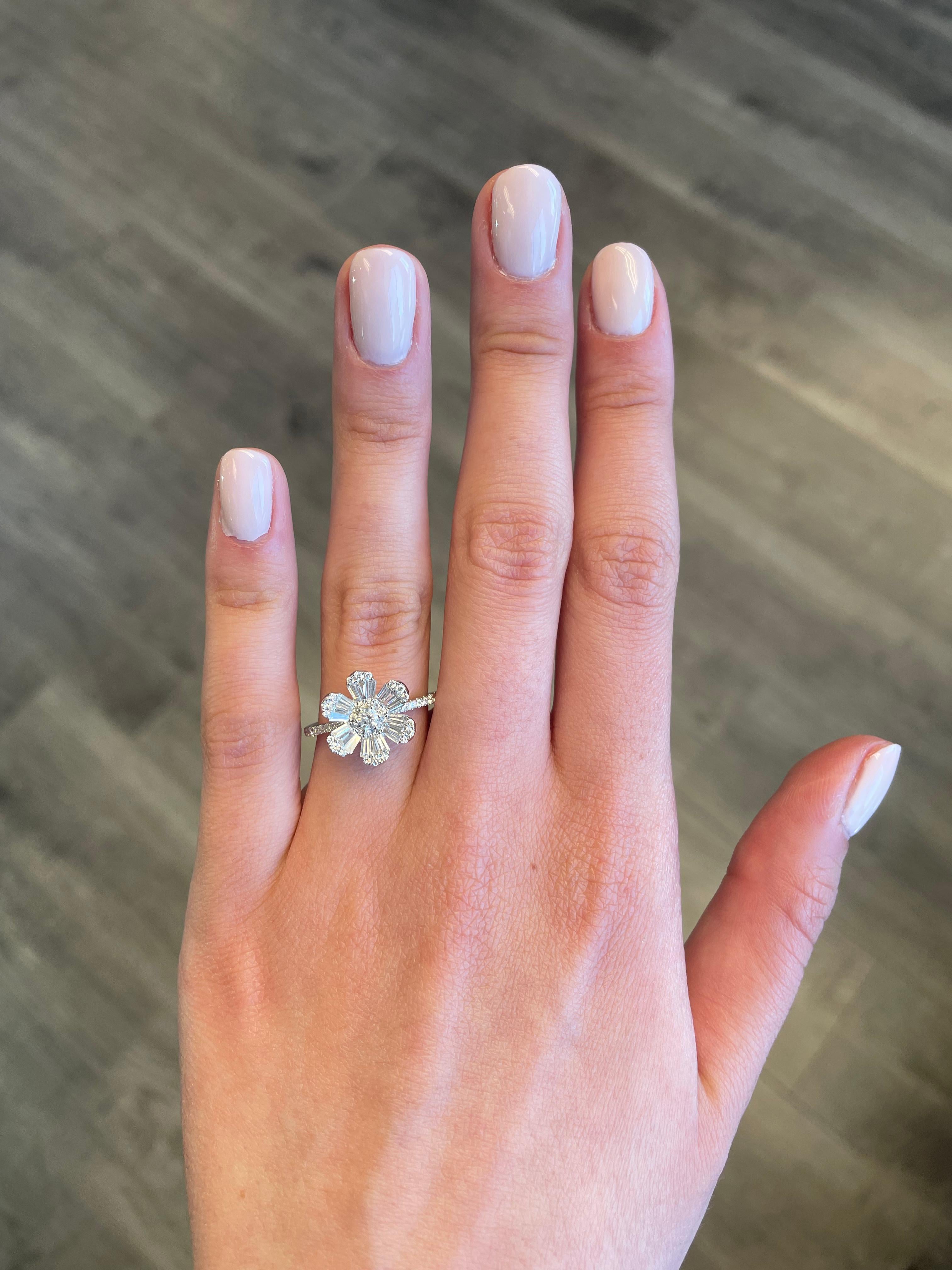 Modern illusion set diamond floral ring with tapered baguette diamonds, by Alexander Beverly Hills. 
65 round brilliant  and tapered baguette cut diamonds, 0.82 carats total. Approximately G/H color and VS clarity. 3.13 grams, 18-karat white