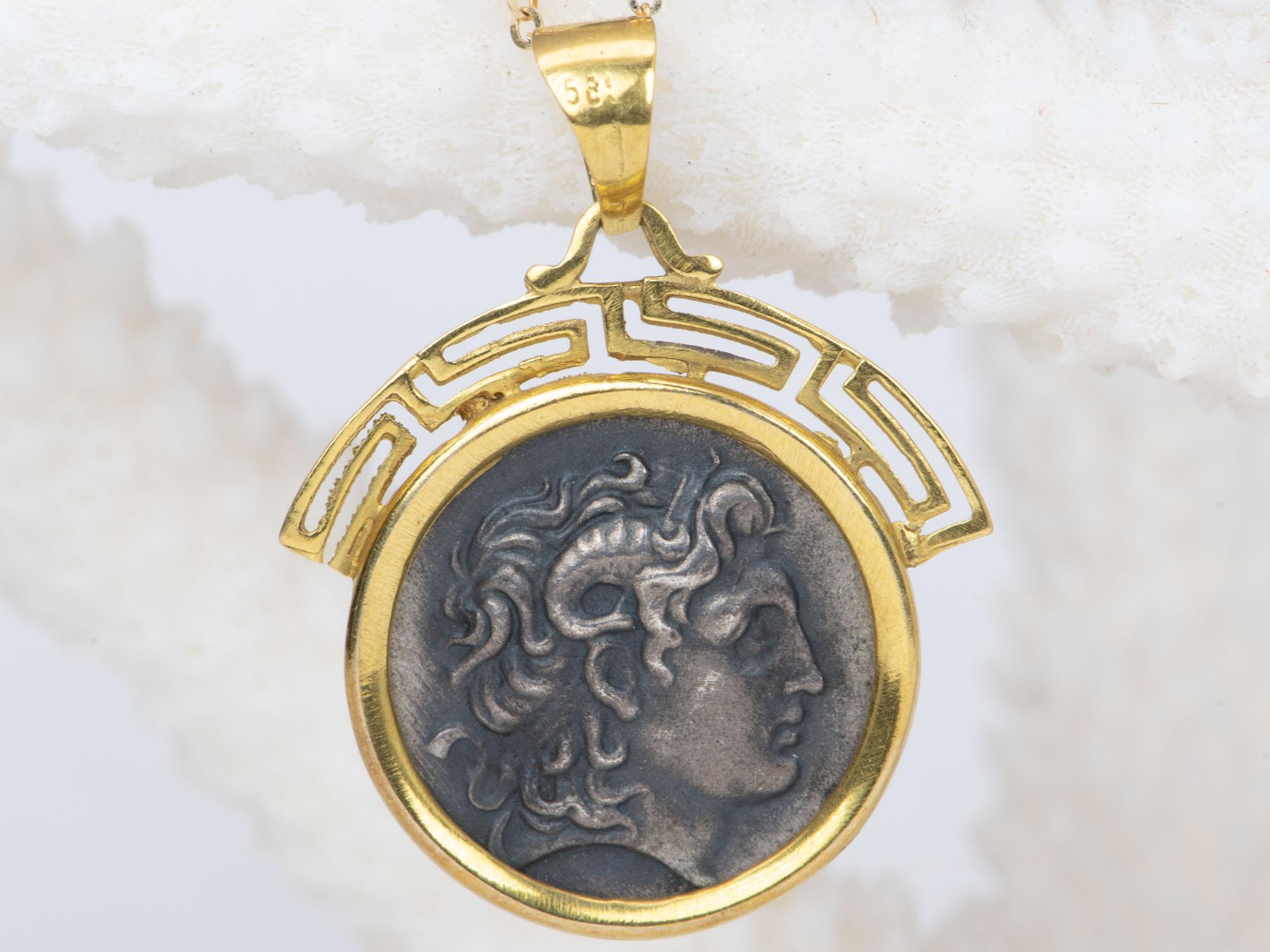 ♥ A solid 14K yellow gold pendant encasing a sterling silver Alexander the Great coin (a replica of a real ancient coin)

♥ The pendant measures 23.8 mm in length, 22.3 mm in width, and 2.2 mm thick.

♥ Material: 14K Yellow Gold

♥ The necklace