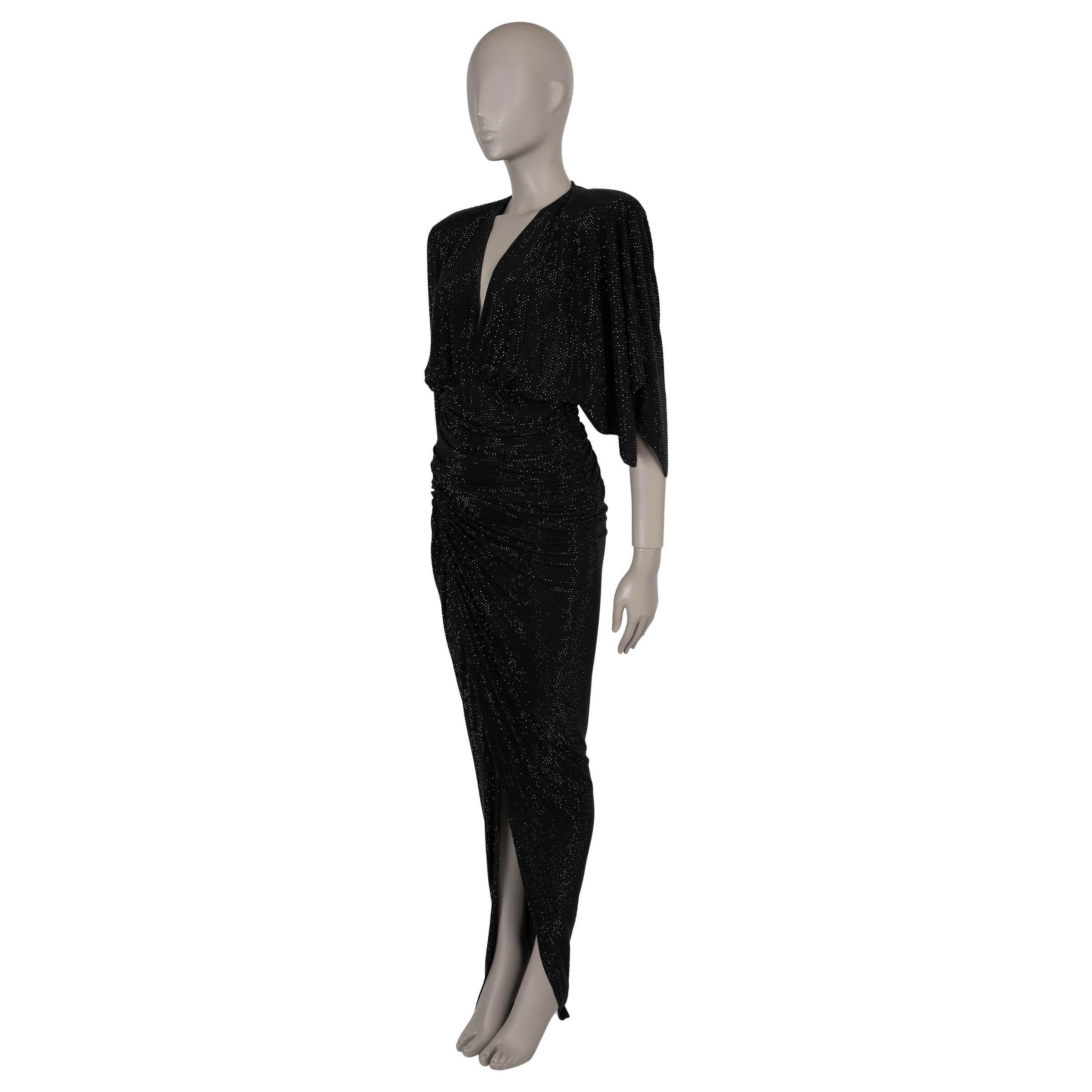 This 100% authentic Alexandre Vauthier gown in black stretch jersey viscose (92%) and elastane (8%) is fully embellished with black glass strass crystals for a dazzling effect. Designed with a striking contrast of structure and fluidity, it features