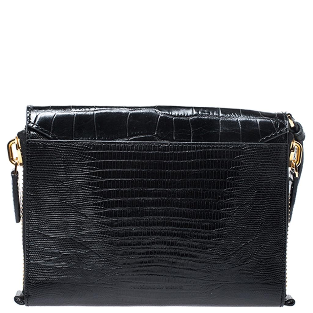 Alexander Wang brings you yet another gorgeous accessory with this clutch. It has been carefully crafted from croc-embossed leather into a simple shape. The front flap opens to reveal a satin interior for your essentials.

Includes: The Luxury