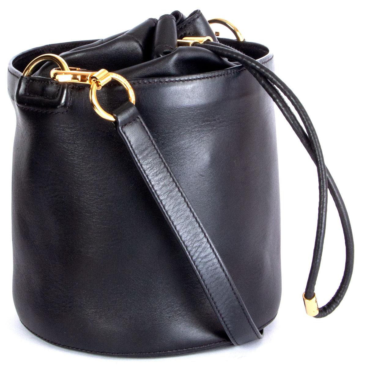 100% authentic Alexander Wang bucket bag in black smooth leather with drawstring closure and gold-tone hardware. Lined in black nylon with one zipper pocket against the back and one open pocket against the front. Comes with an adjustable shoulder