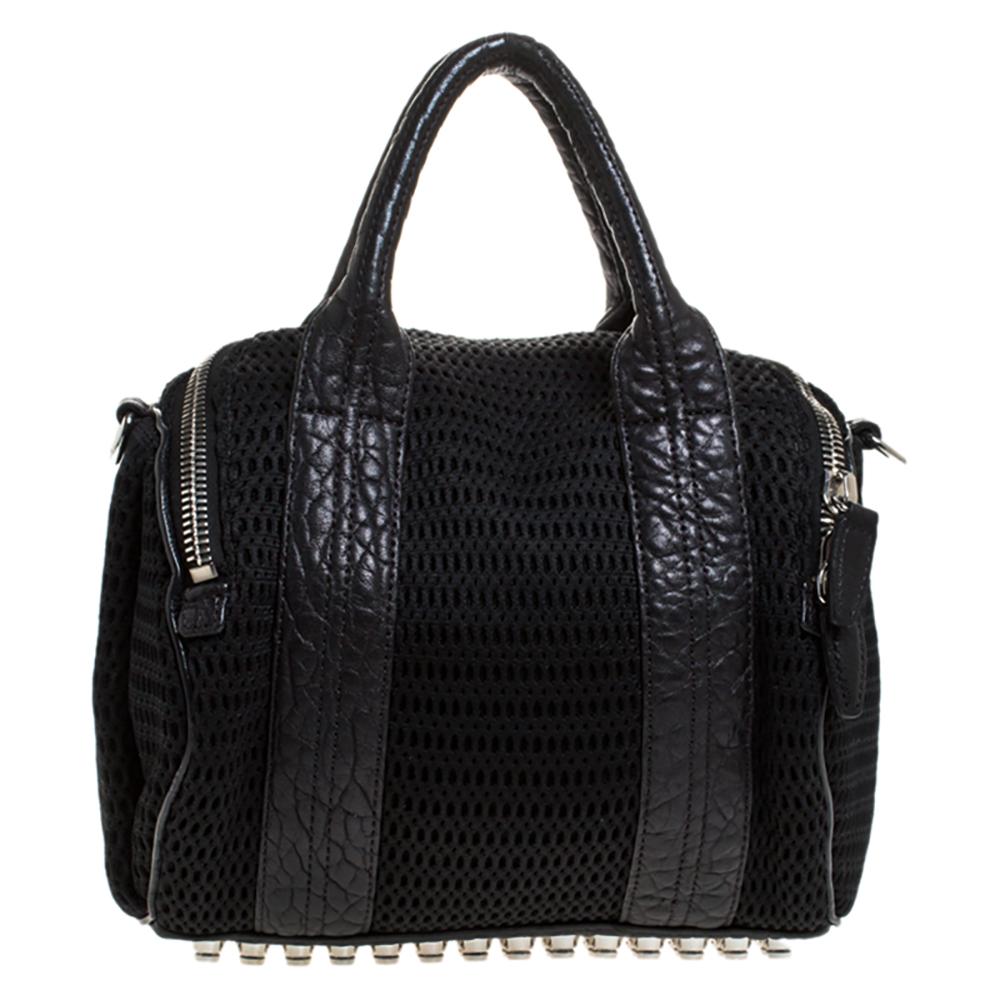 Creations like this Rocco bag by Alexander Wang never go out of style. This black bag is crafted from crochet fabric and leather and it features dual handles and silver-tone hardware. The top zipper opens to a nylon interior sized to carry your