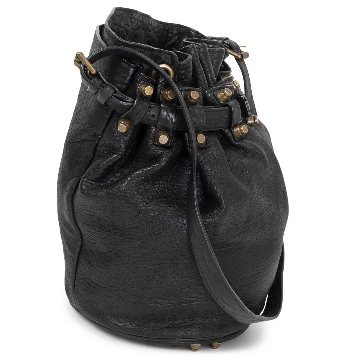 100% authentic Alexander Wang Diego bucket bag in black grained leather and chunyk antique gold-tone studs. Open pocket at the back. Closes with a drawstring. Lined in black nylon with a zipper pocket against the back. Has been carried with some