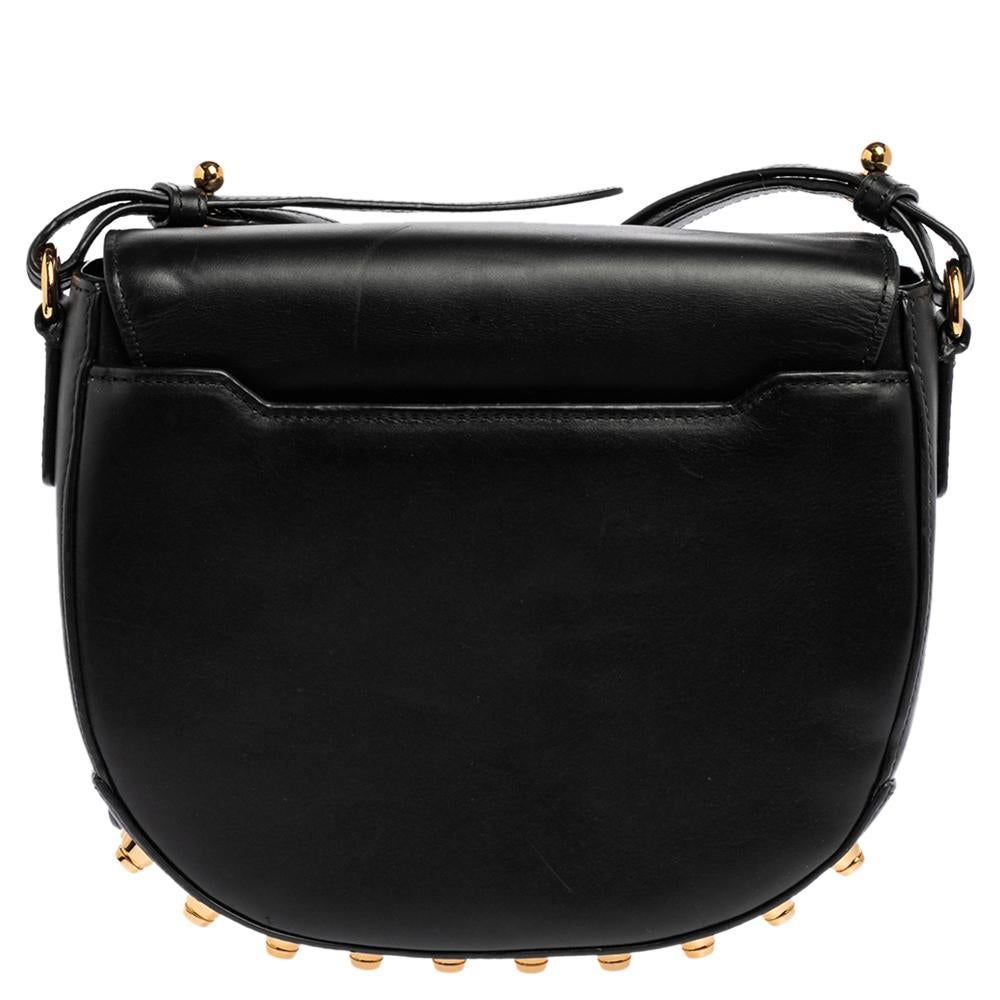 This chic Lia bag from Alexander Wang offers ample style and reliability. Crafted from quality leather, the bag features a single shoulder strap and protective metal feet at the bottom. The front flap opens to a fabric interior that will hold all