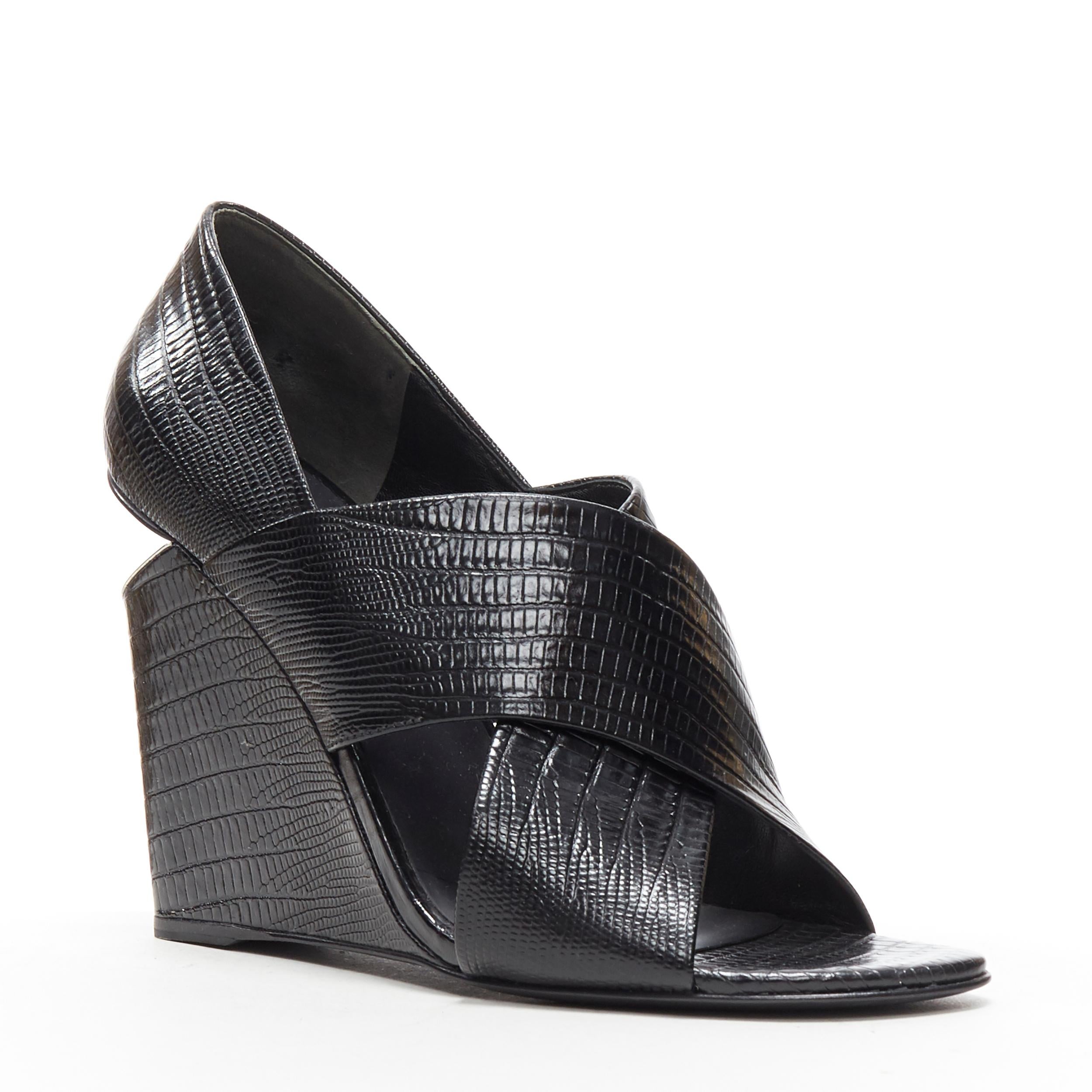 ALEXANDER WANG black mock lizard print cross strap cut out wedge sandal EU38
Brand: Alexander Wang
Designer: Alexander Wang
Model Name / Style: Wedge
Material: Leather
Color: Black
Pattern: Solid
Extra Detail: Ultra High (4 in & Higher) heel height.