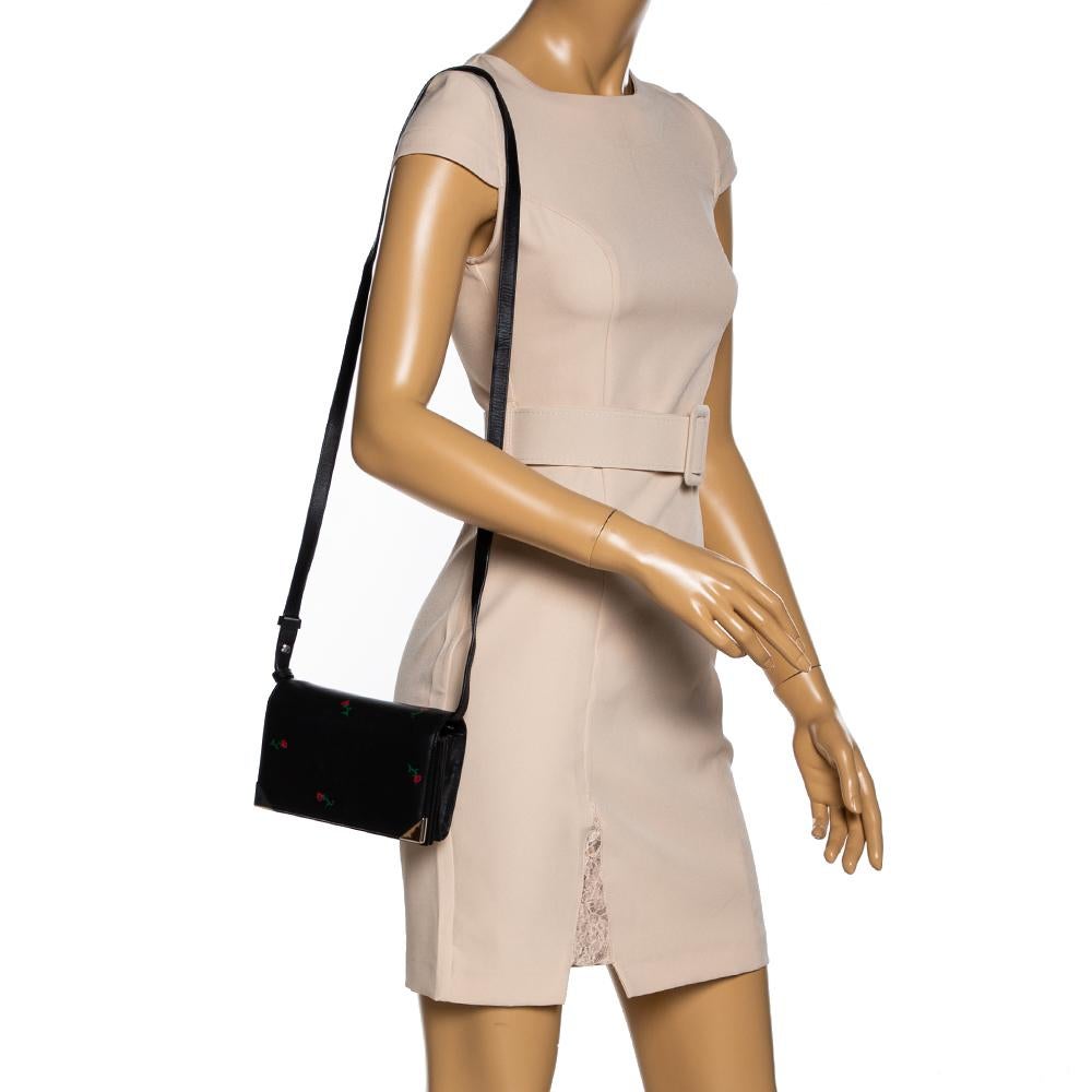 Alexander Wang is a celebrated designer whose creations are much sought-after and this Prisma Biker bag is a testimony to that. The black beauty comes crafted from leather in a sturdy silhouette and embossed with red roses. The front flap has