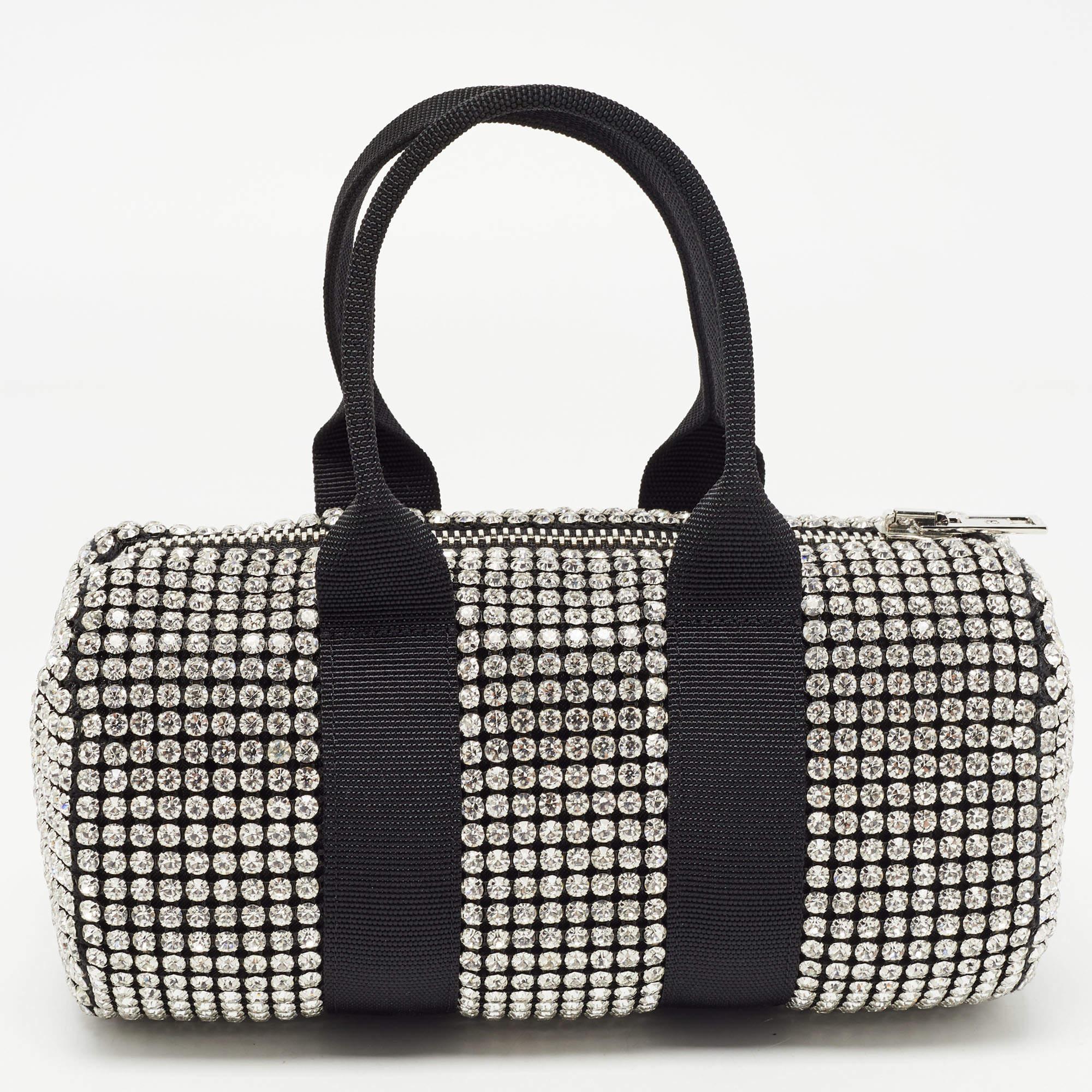 Alexander Wang's Mini Cruiser Duffle bag is decorated with shimmering crystals all over the exterior. It has two fabric handles and a nylon interior.

 Includes: Original Box, Info Booklet, Extra Embellishment
