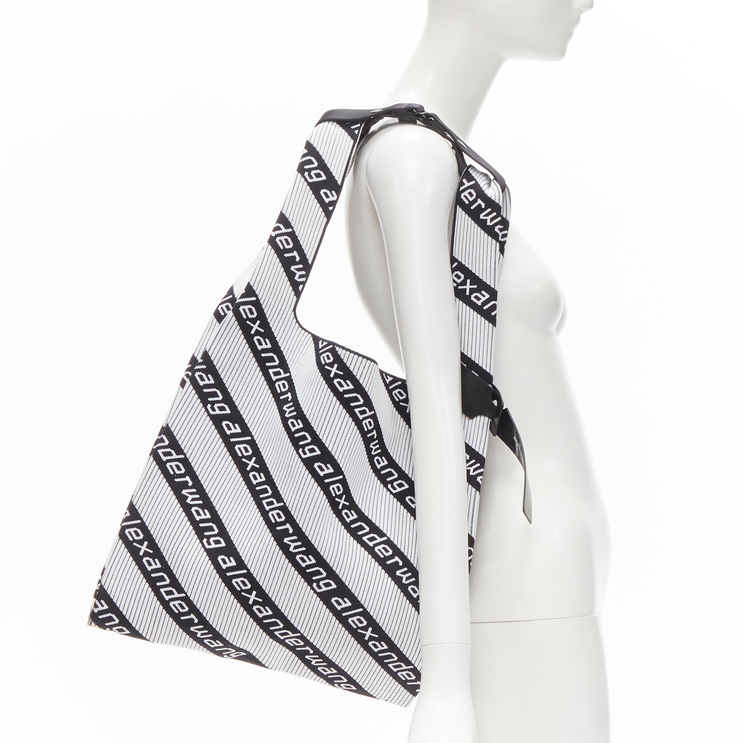 ALEXANDER WANG black white logo intarsia fabric shopper tote bag 
Reference: ANWU/A00012 
Brand: Alexander Wang 
Material: Fabric 
Color: White 
Pattern: Logo 
Extra Detail: Ribbed fabric. Buckle strap on handle to wear on shoulder. Rubber logo tag