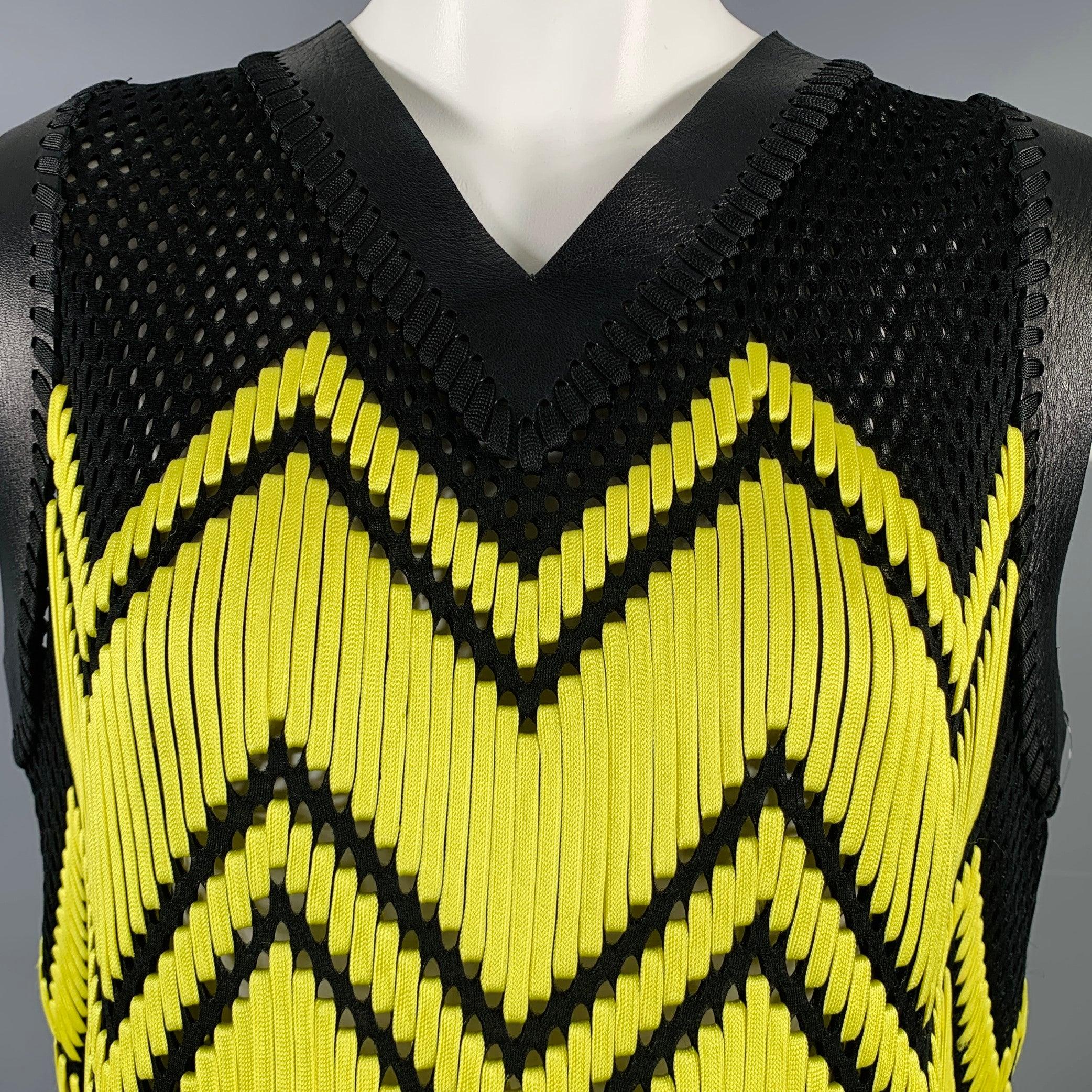 ALEXANDER WANG cocktail dress
in a black and yellow polyester fabric featuring a black mesh style with woven yellow laces forming a geometric pattern, lambskin leather trim, and V-neck.Very Good Pre-Owned Condition. 

Marked:   OS 

Measurements: 
