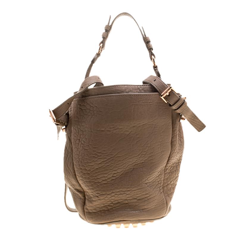 This daring and remarkably bucket bag by Alexander Wang is crafted for the bold and beautiful. This Diego bucket bag is crafted from textured leather, comes with two straps, both adjustable for your convenience, in small and large size and is well