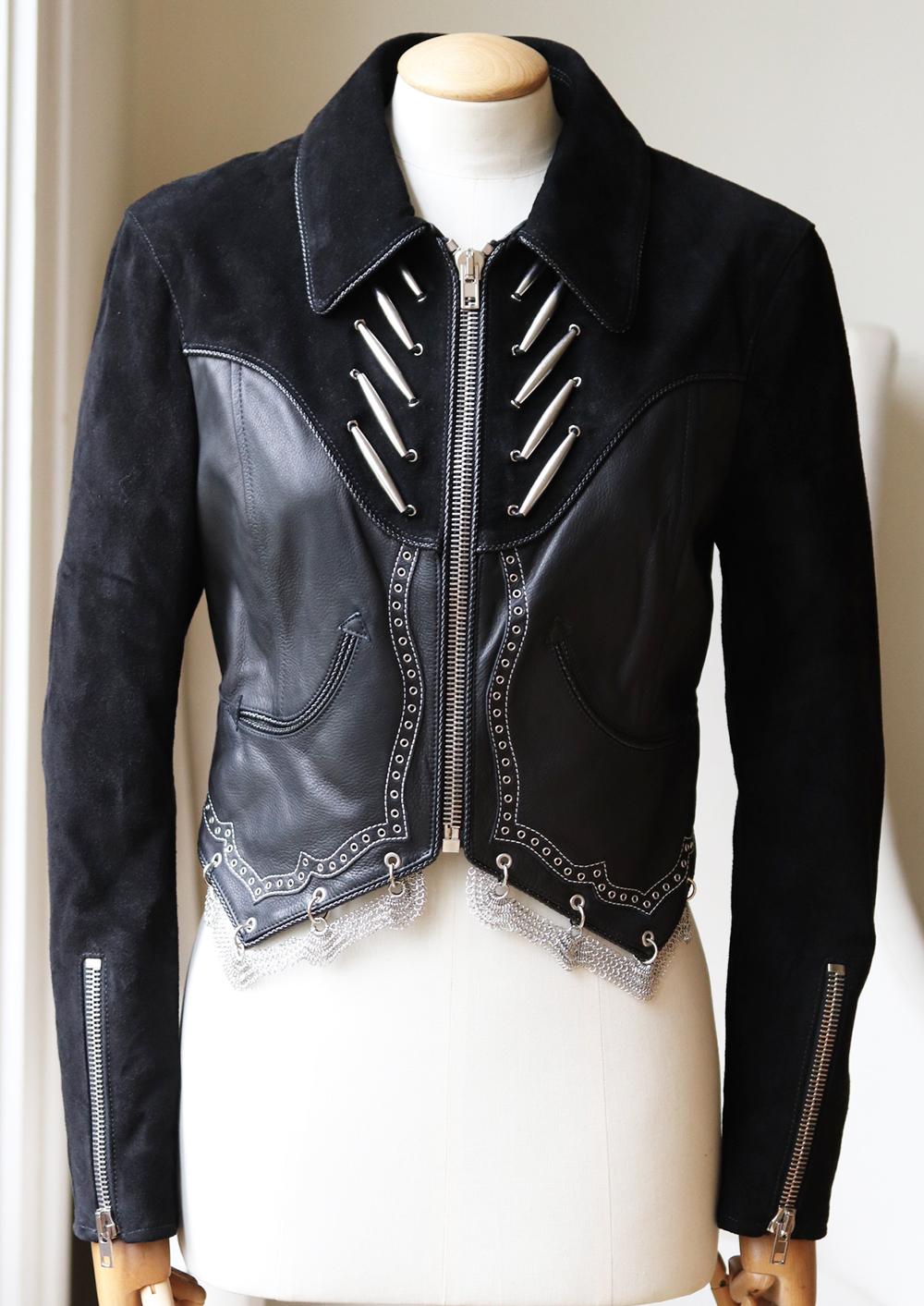Alexander Wang takes inspiration from the glamour and attitude of Western-style.
One of the brand's standout pieces, this western-style jacket is made from buttery soft and textured leather in black with silver-tone metal detail. 
Black suede and