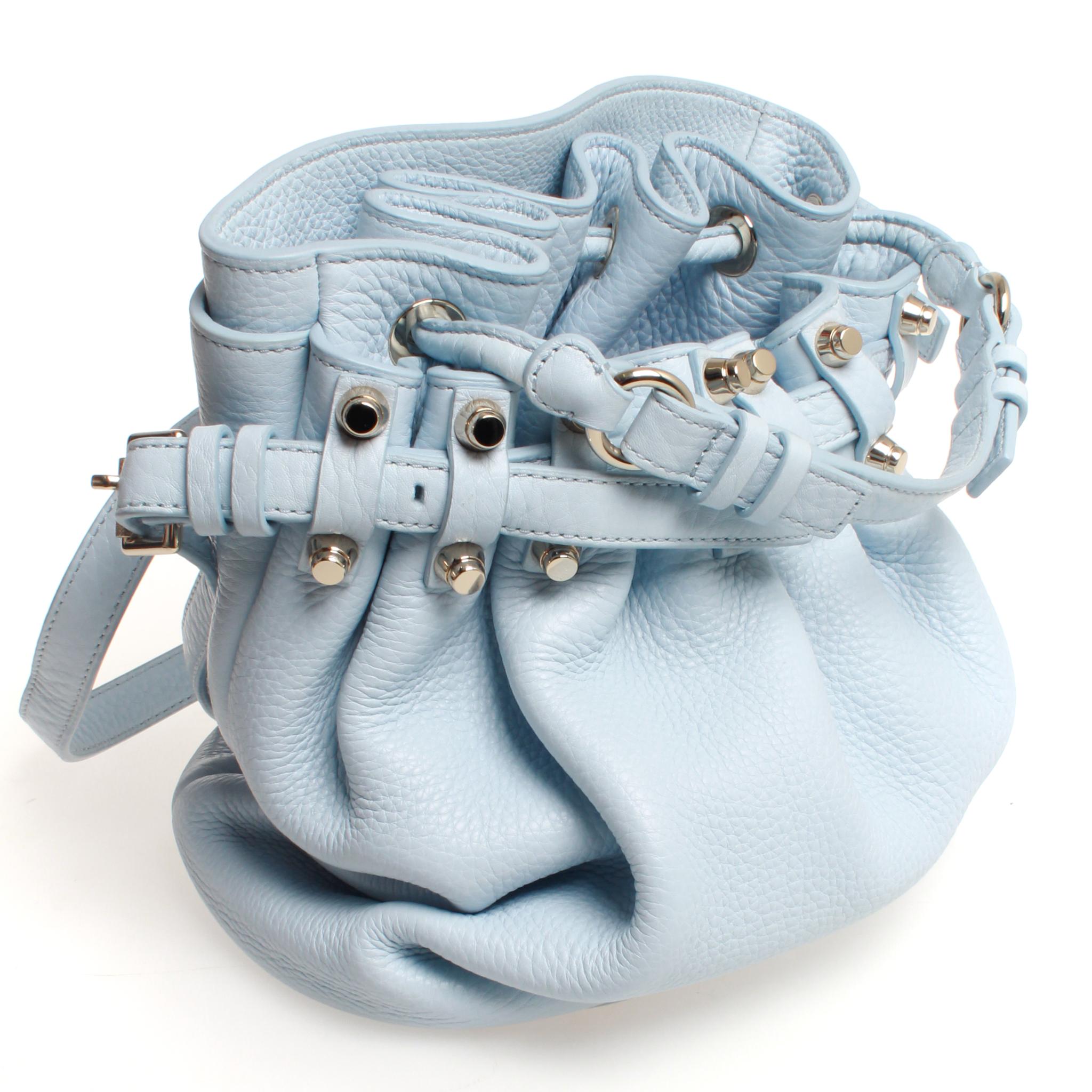 Buttery soft Alexander Wang Diego bucket bag with silver toned hardware. This bag features sky blue pebbled leather, lined interior with inner zip pocket, adjustable shoulder strap, silver hardware with silver studded feet to protect the base of the