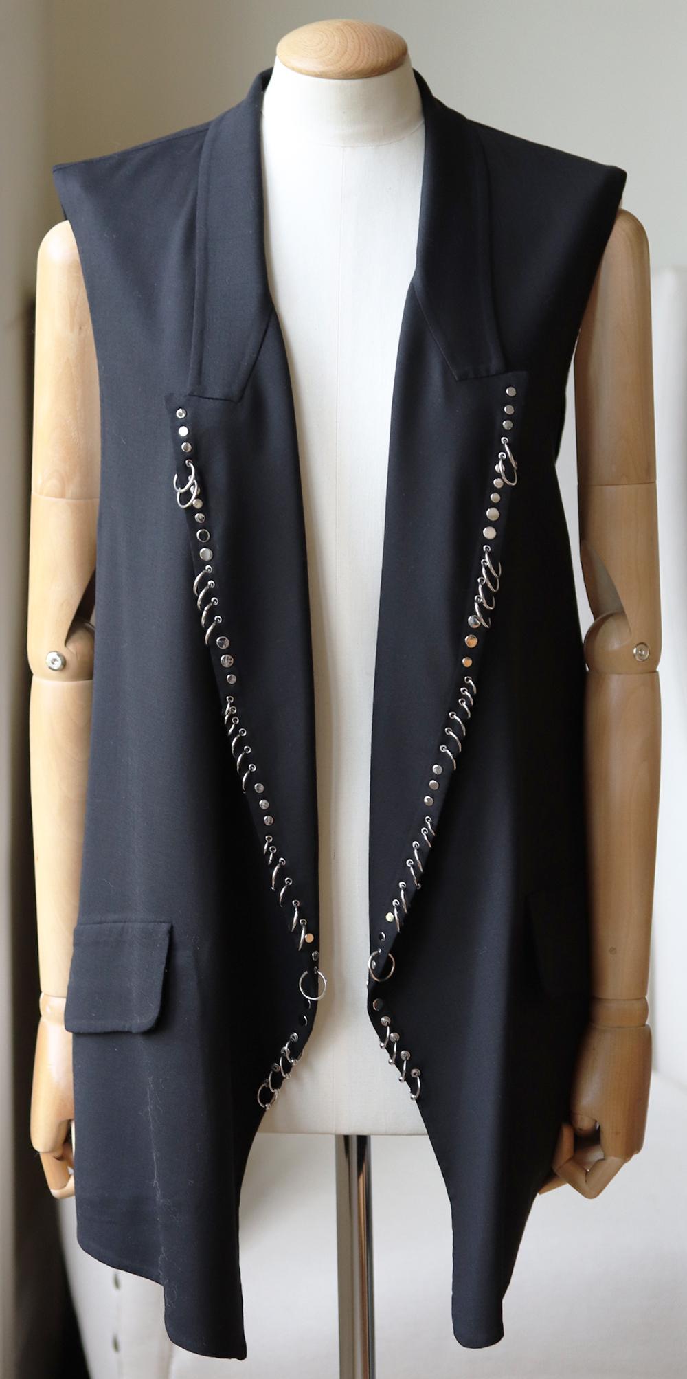 This Alexander Wang vest has been finished with weighty silver stud and piercing embellishments that a signature to each season, this slim fit piece hangs perfectly and fall just below the waist. 
Black wool.
Slips on.
95% Virgin wool, 5%