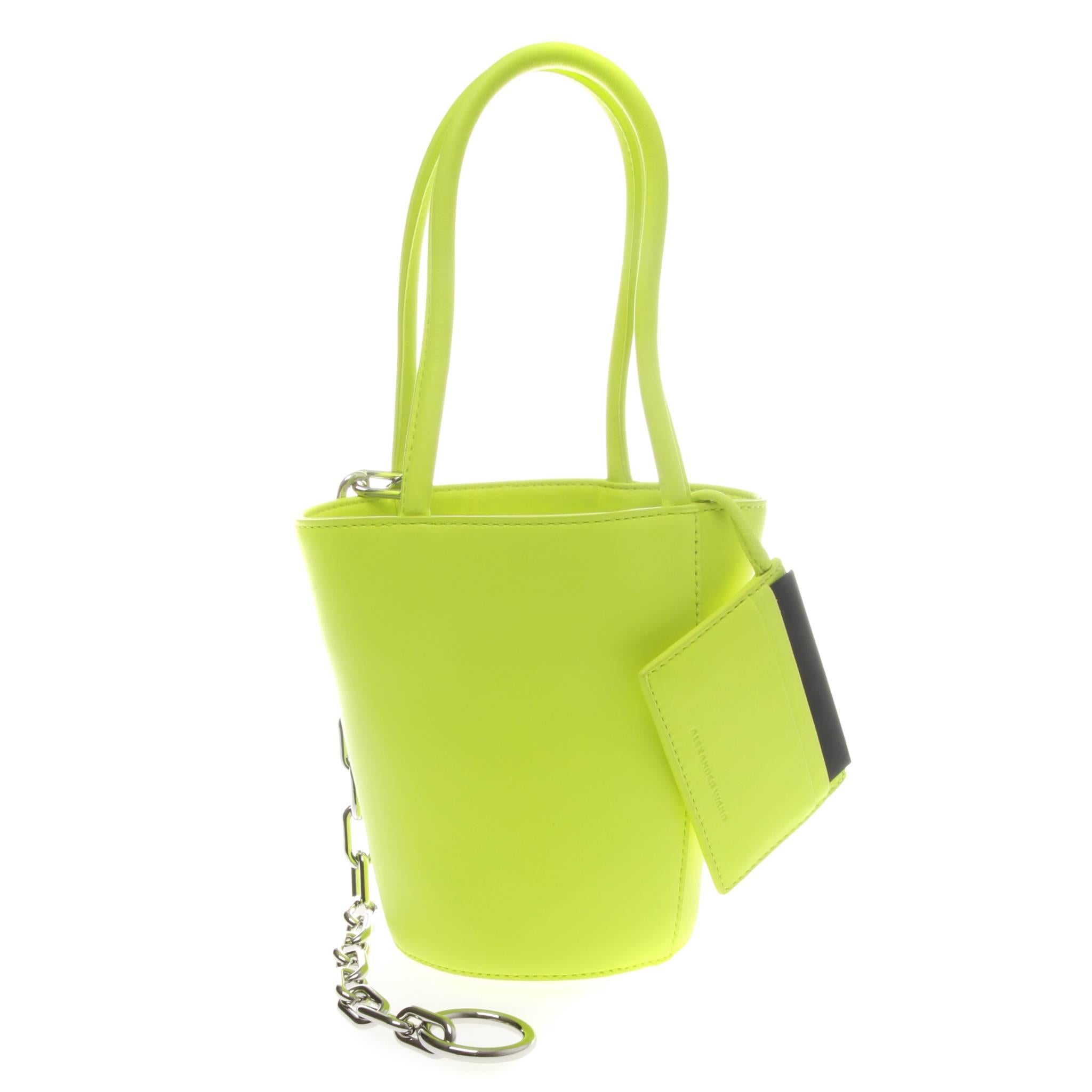 An eye-catching fluro green leather Roxy mini bucket bag by Alexander Wang,
featuring a round body, open top design, round top handles, internal slip pocket and silver-tone chain handle.