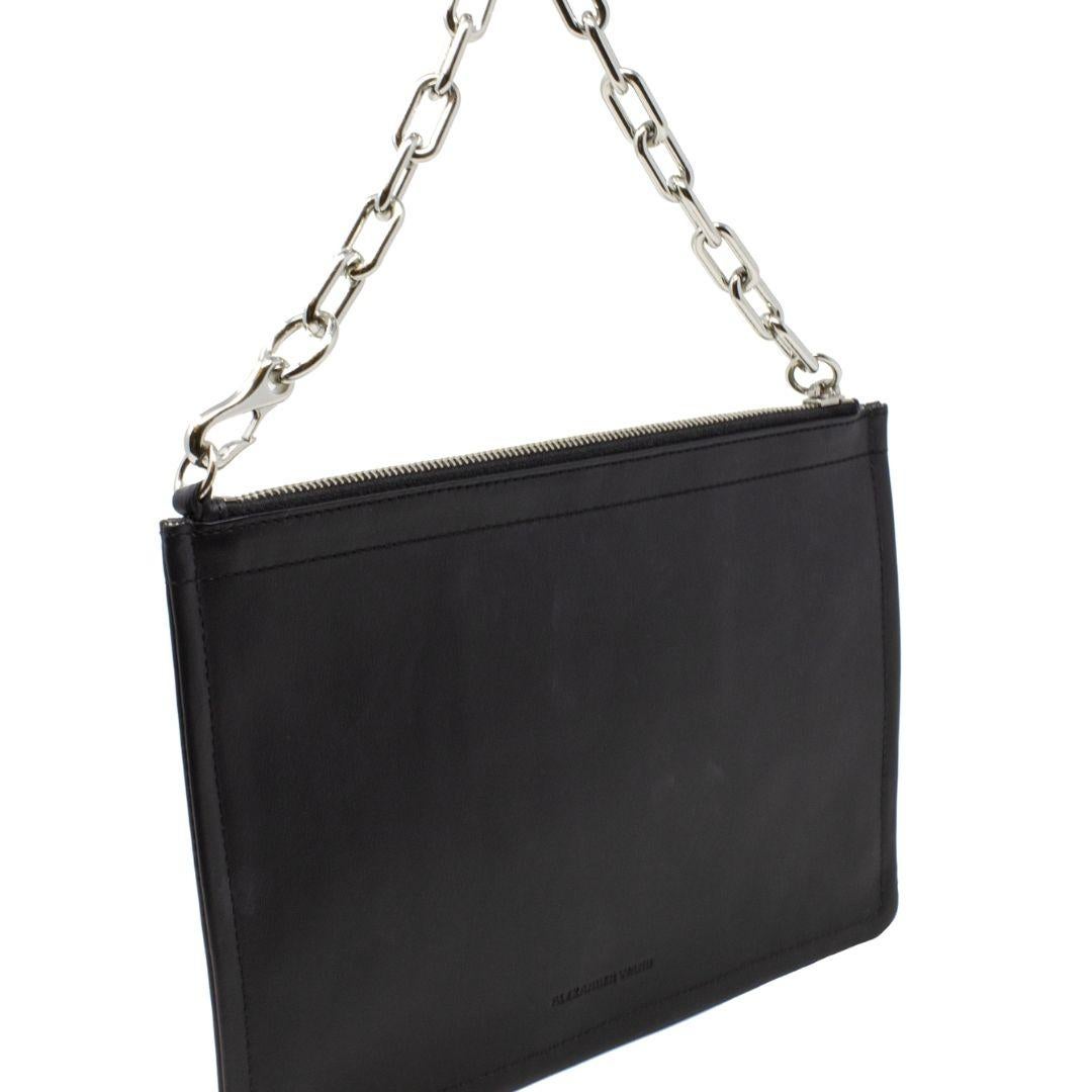 Struggling to match a bag to your outfit? This pochette will solve that issue. The simple silhouette with the signature biker chain and hook clip provides just the right amount of edge yet cohesiveness. The top zip opens up to an interior that has