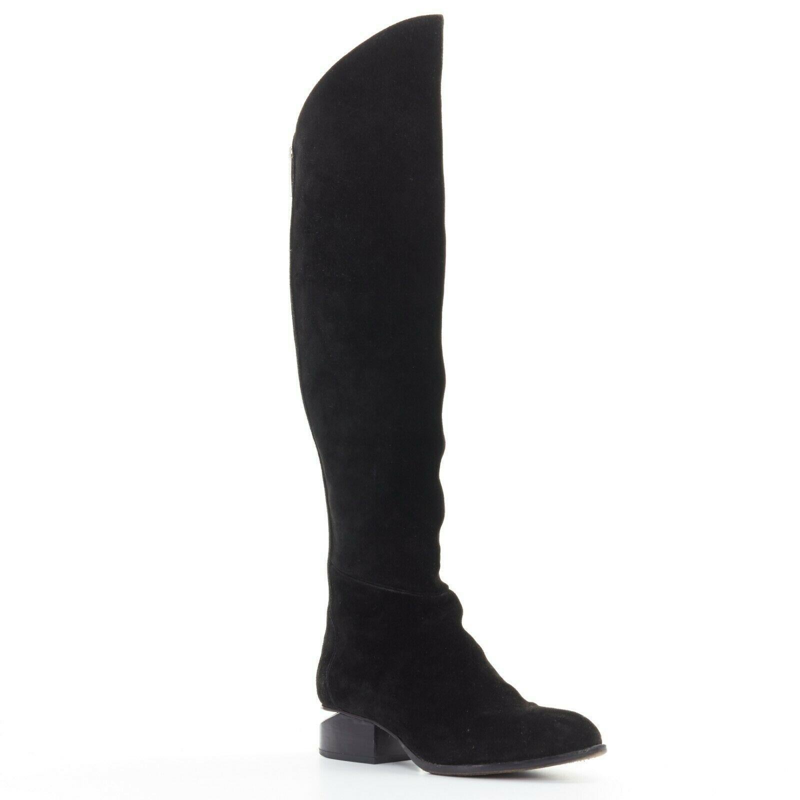 ALEXANDER WANG Sigrid black suede leather zip back cut out heel knee boot EU37

ALEXANDER WANG
Sigrid boot. Black suede leather upper. Silver-tone hardware. Signature cut out stacked heel. Exposed zip trimming at back. Pointed almond toe. Knee high