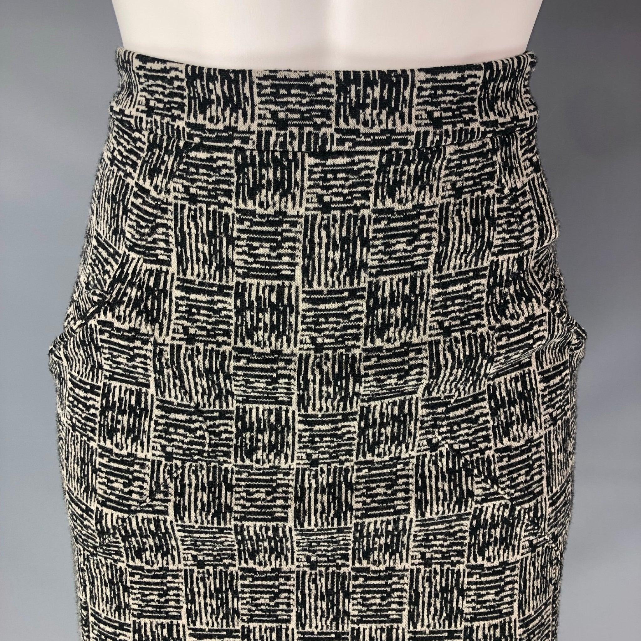 ALEXANDER WANG below knee pencil skirt comes in a black and grey stretch virgin wool blend featuring back invisible Zip closure and Flat Front and two frontal slit pockets. Excellent Pre-Owned Condition.  

Marked:   size 4 

Measurements: 
  Waist: