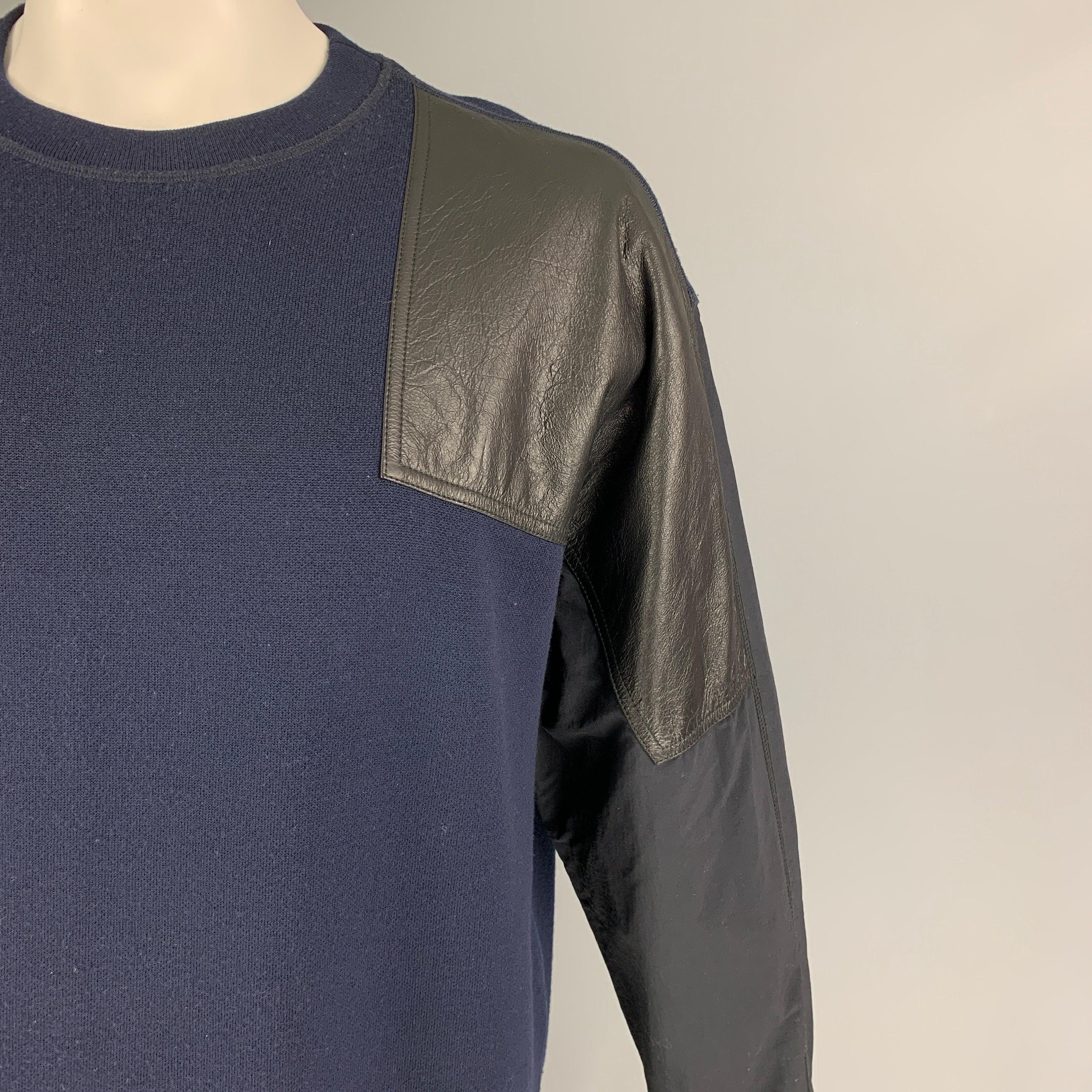 ALEXANDER WANG pullover comes in a navy & black mixed materials featuring
 a faux leather patch, and a crew-neck.
Excellent
Pre-Owned Condition. 

Marked:   48 

Measurements: 
 
Shoulder:
23.5 inches Chest: 50 inches Sleeve: 24 inches Length: 28