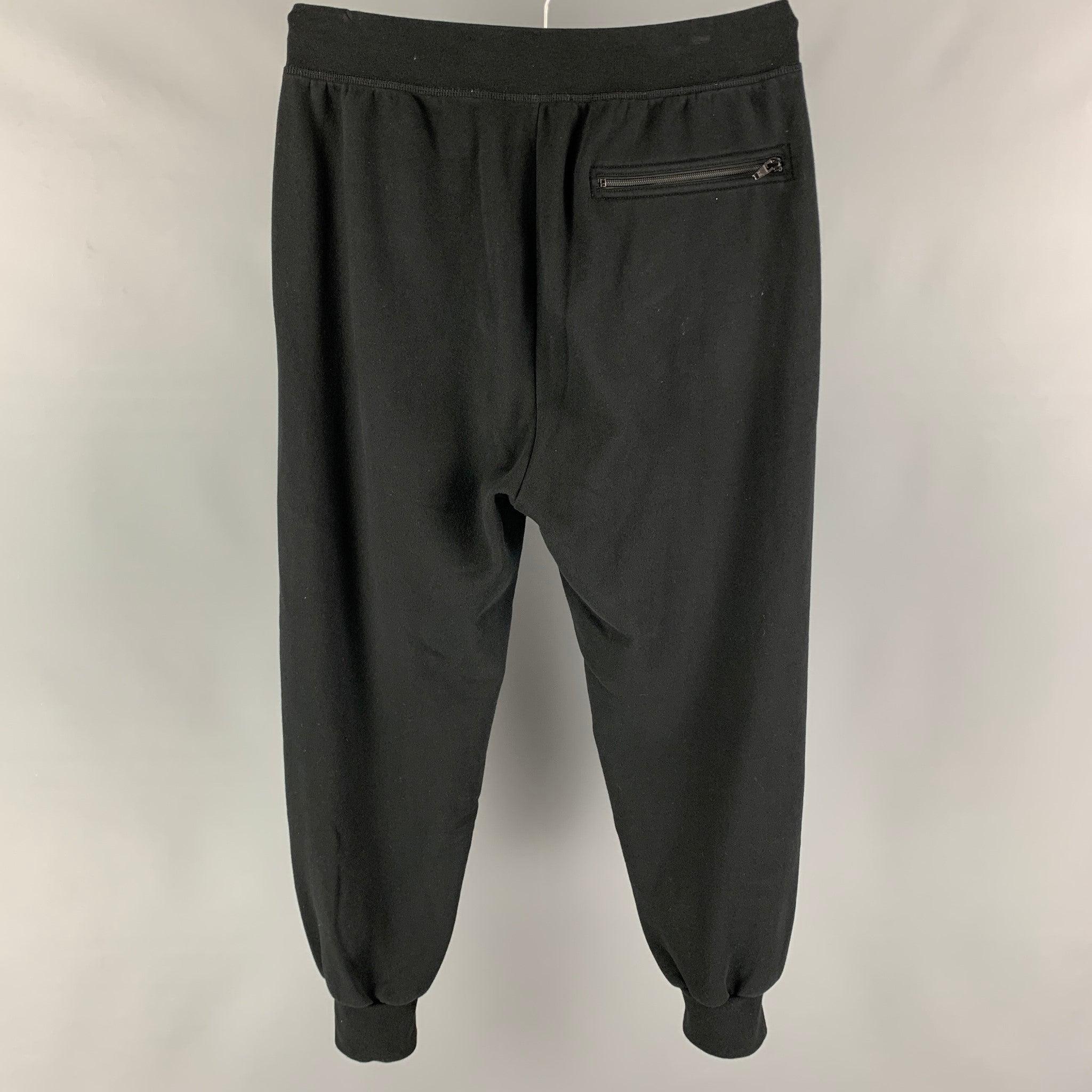 ALEXANDER WAND pants comes in a black cotton / polyester featuring a jogger style, hook & loop detail, and a zip fly closure.
Very Good
Pre-Owned Condition. 

Marked:   M 

Measurements: 
  Waist: 32 inches Rise: 14 inches Inseam: 28 inches Leg